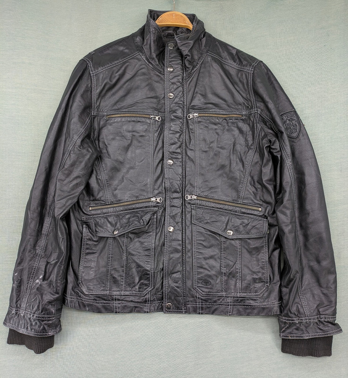 Tom Tailor black leather jacket vintage style with multiple pockets and contrast stitching.