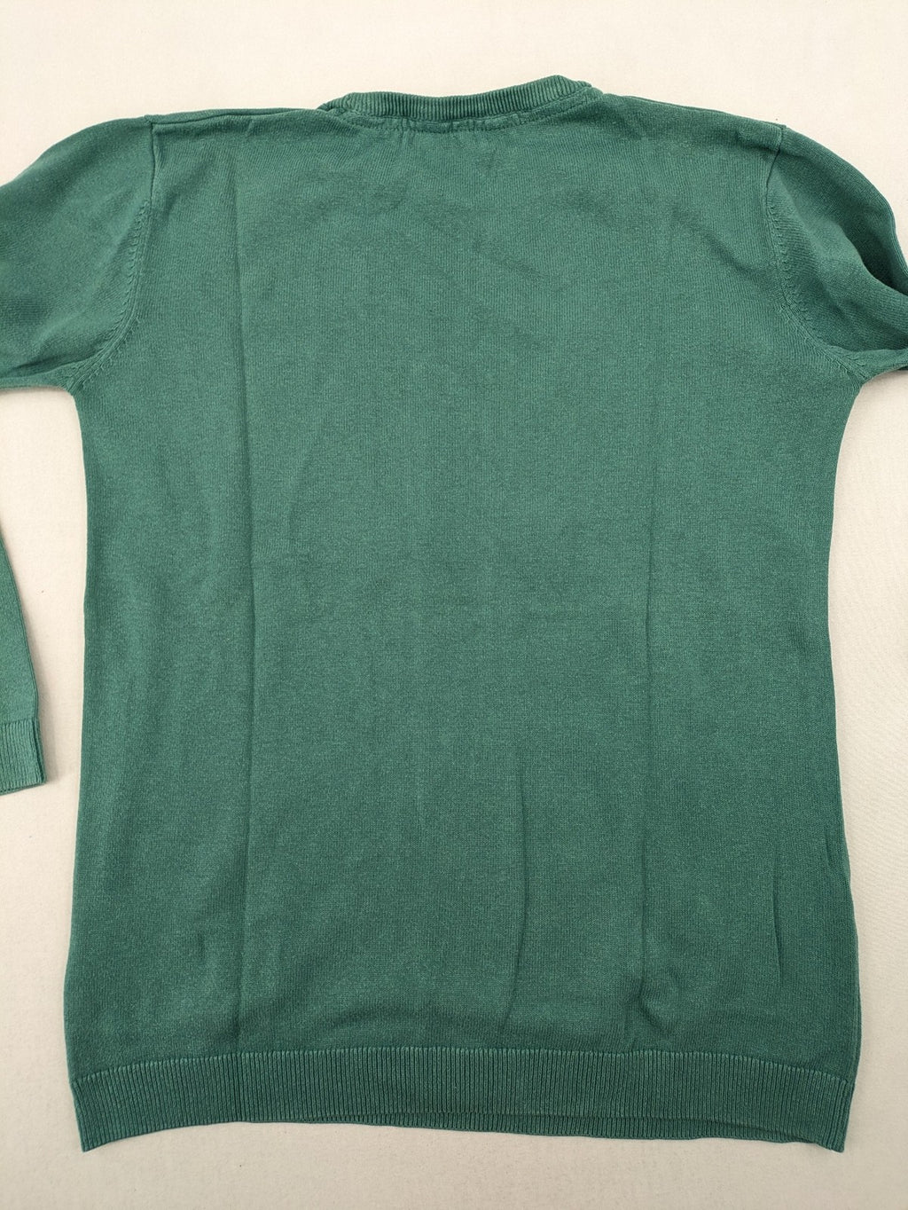 BESTies green turtle neck jumper with white skateboard graphic and ribbed cuffs.