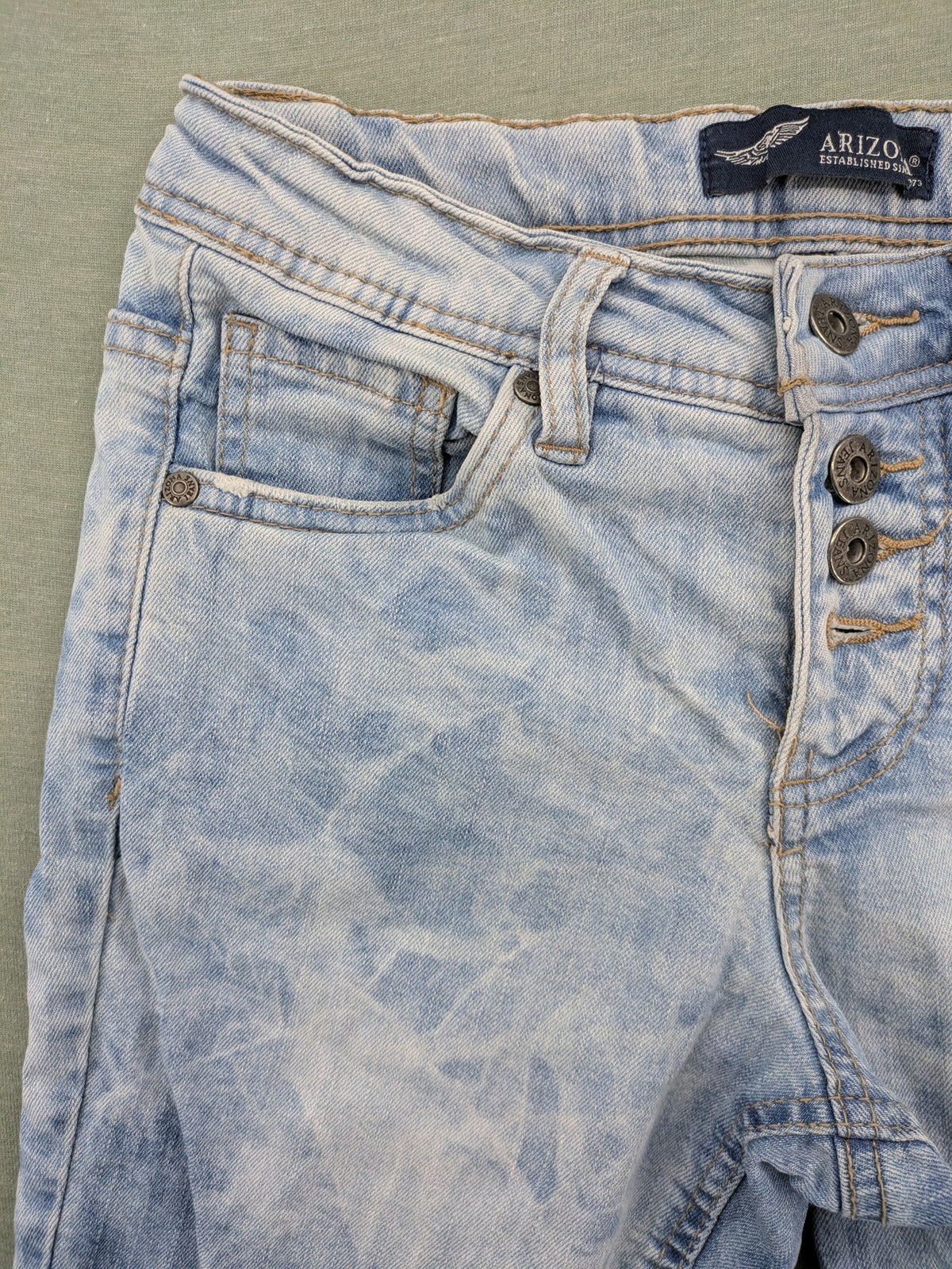 Arizona blue flare jeans with acid wash, button fly, and stretch denim material.