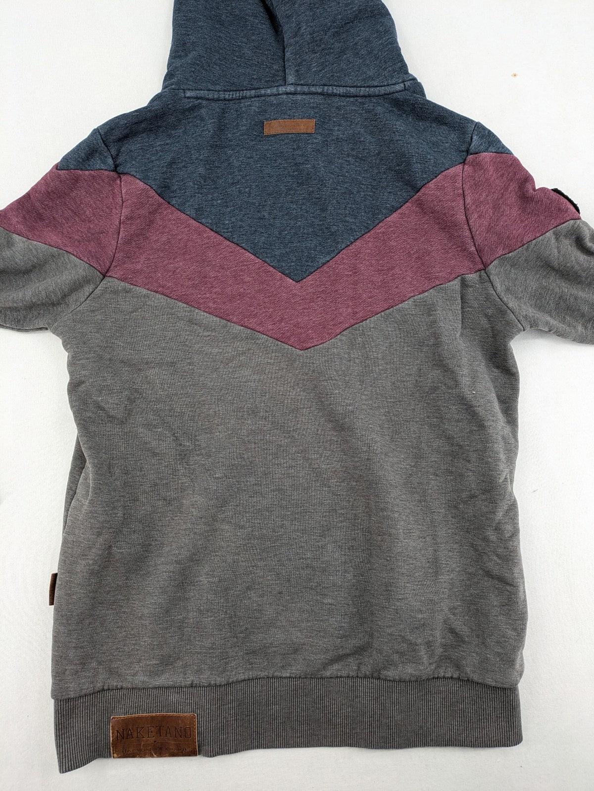 Naketano multicolor turtle neck jumper with button placket and anchor patches.