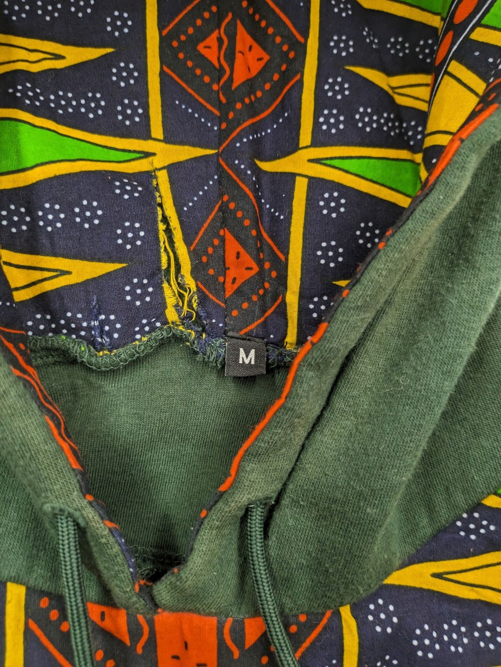 Diweye Creations multi turtle neck jumper with vibrant African print and soft green material.
