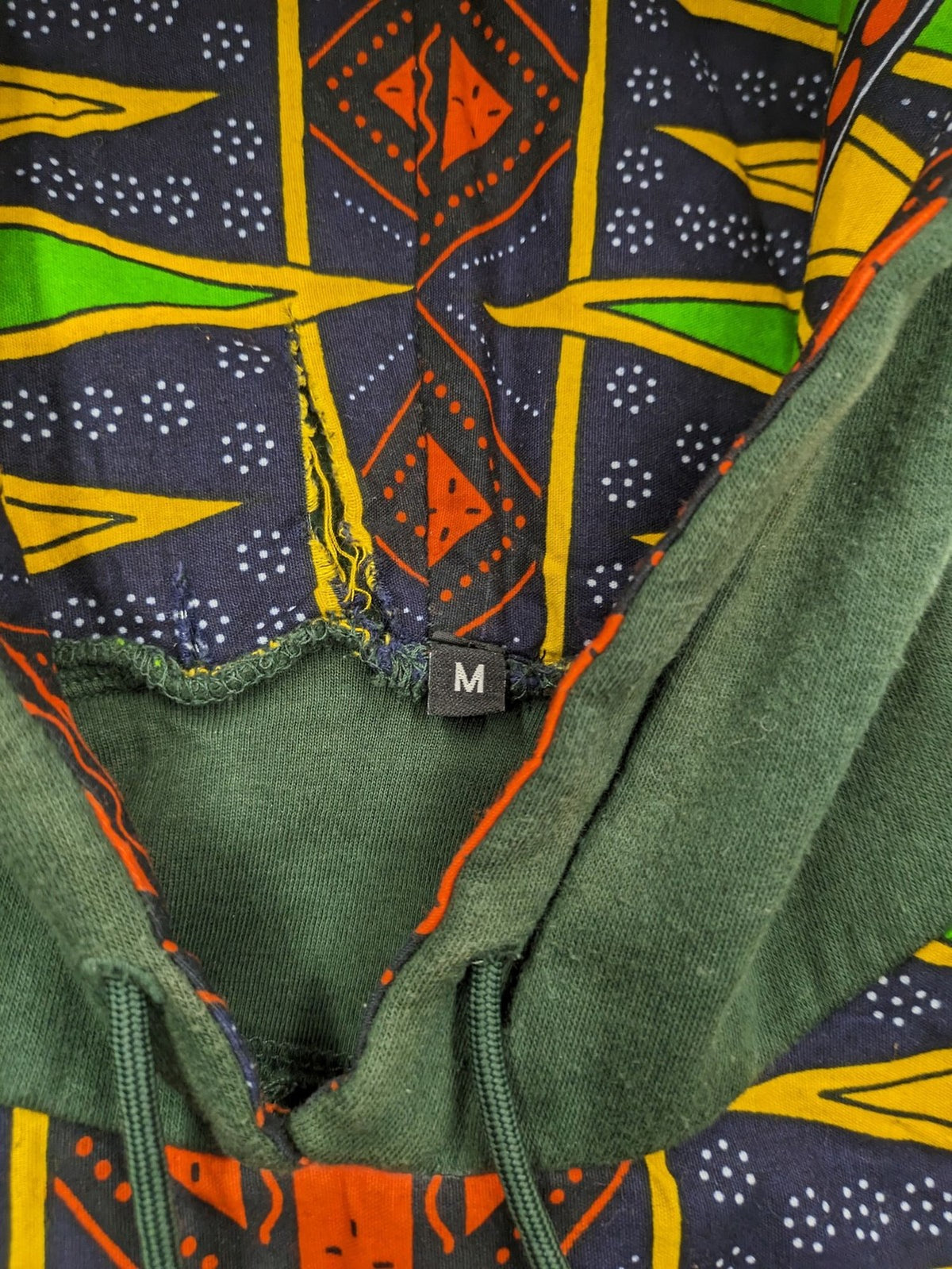 Diweye Creations multi turtle neck jumper with vibrant African print and soft green material.