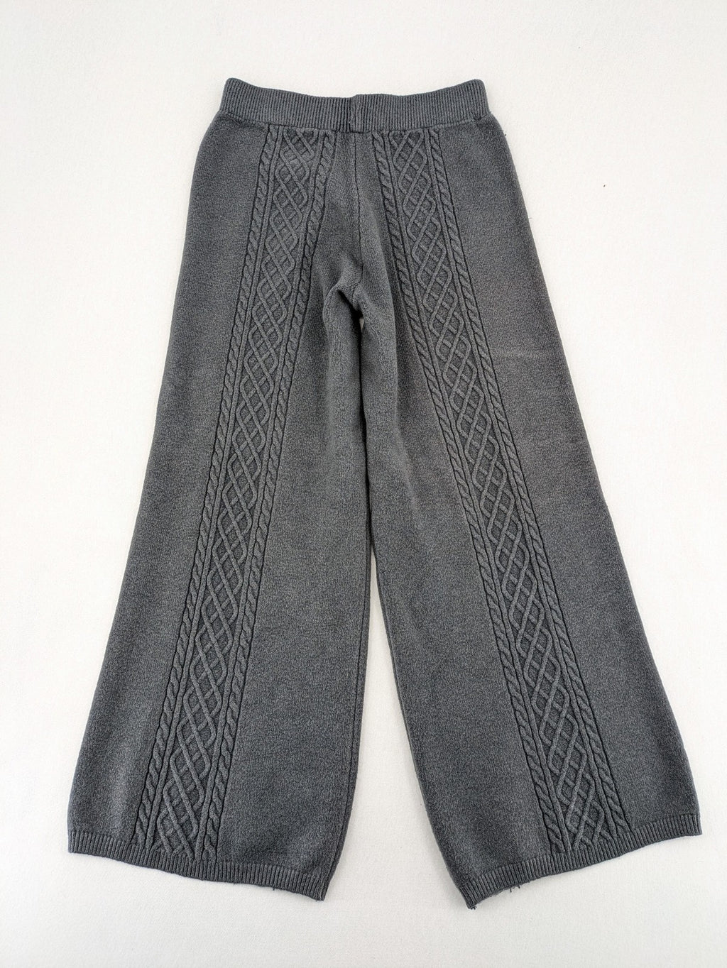 Grey pants with cable knit pattern, wide leg, ribbed waistband, 100% polyester.