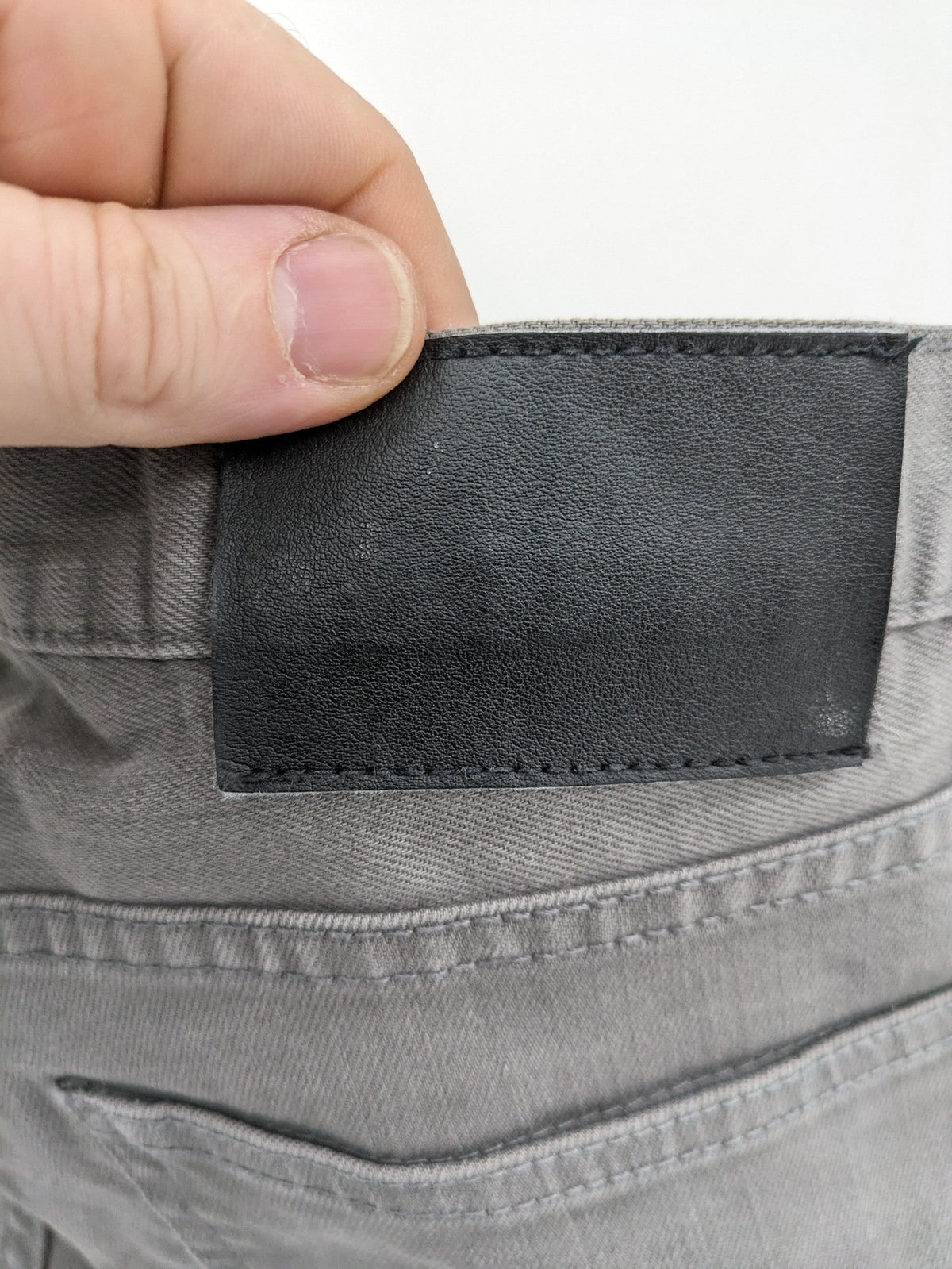 H&M grey skinny fit jeans with button closure and five-pocket design, cotton-elastane blend.