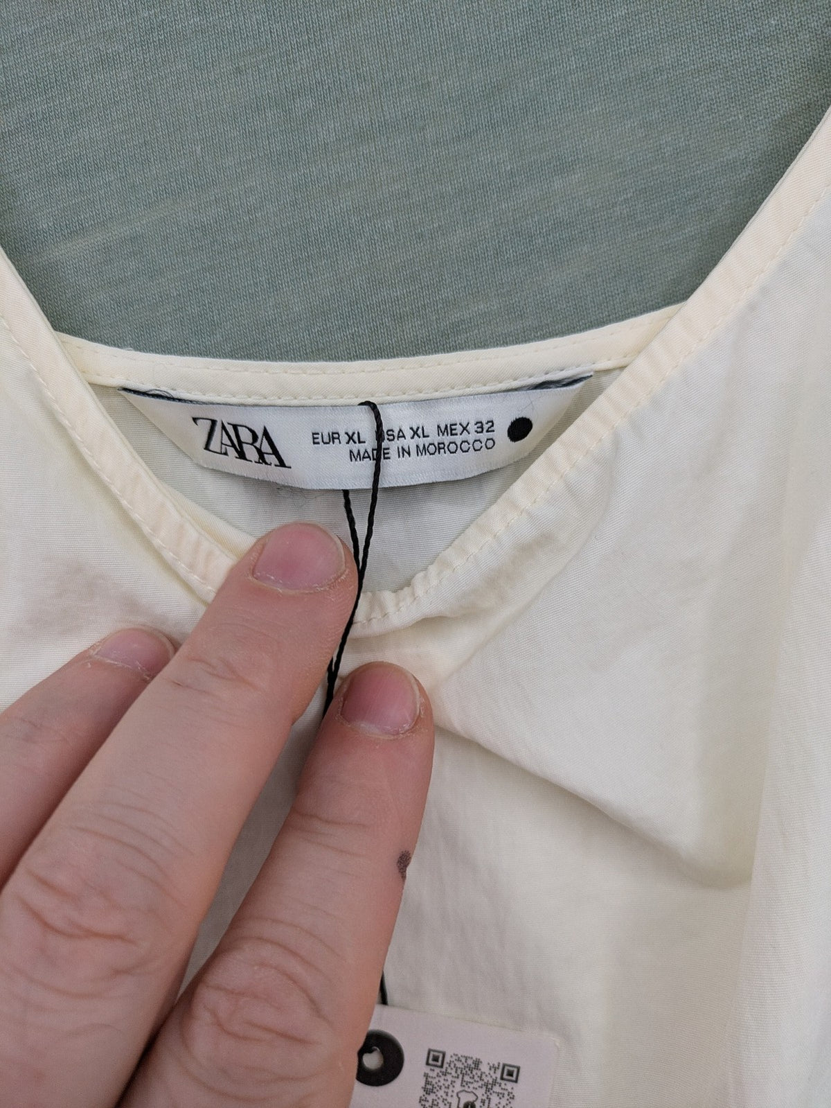 Zara cream tank top, sleeveless design, smooth polyamide fabric, minimalist style.