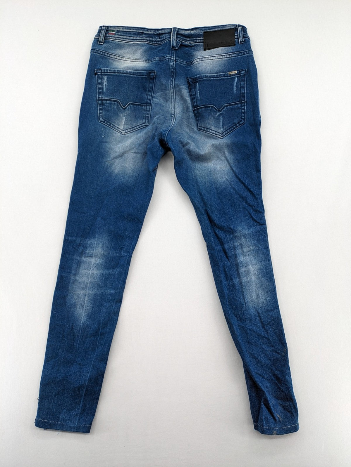 Diesel blue straight jeans with distressed details and ripped accents, made of cotton.
