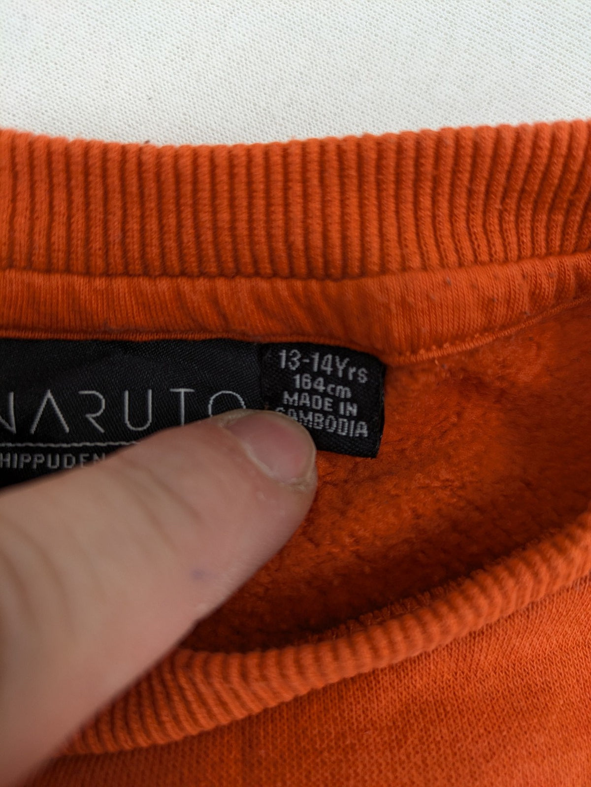 Naruto Shippuden orange sweatshirt featuring vibrant Naruto Uzumaki graphic print, classic crew neck.