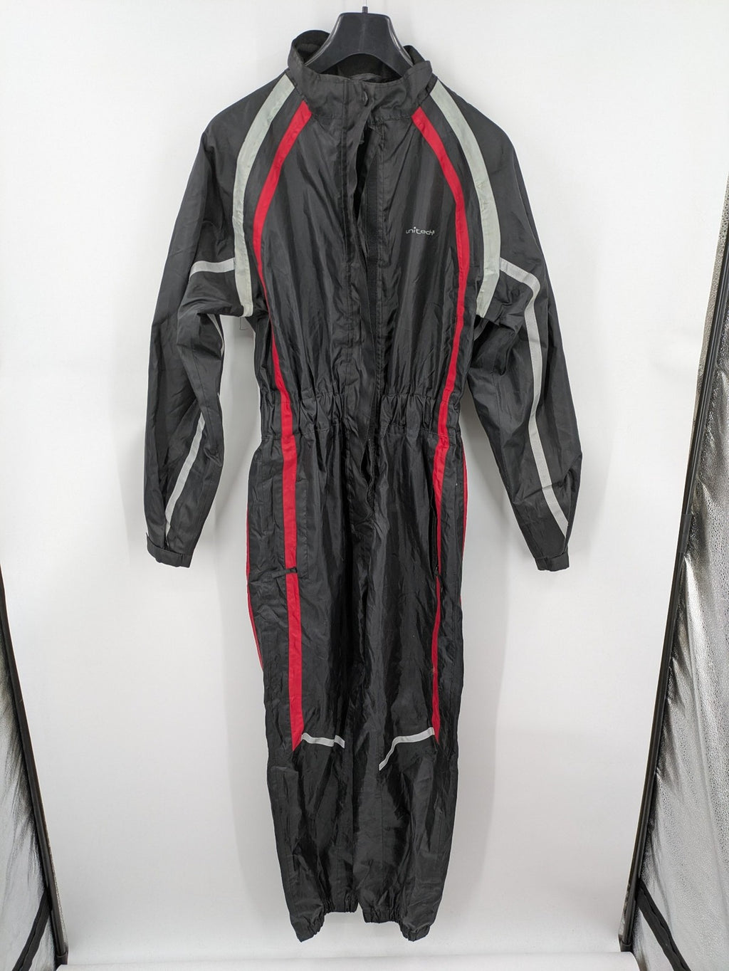 Unitech black rain suit with red reflective stripes and full zipper, size M.