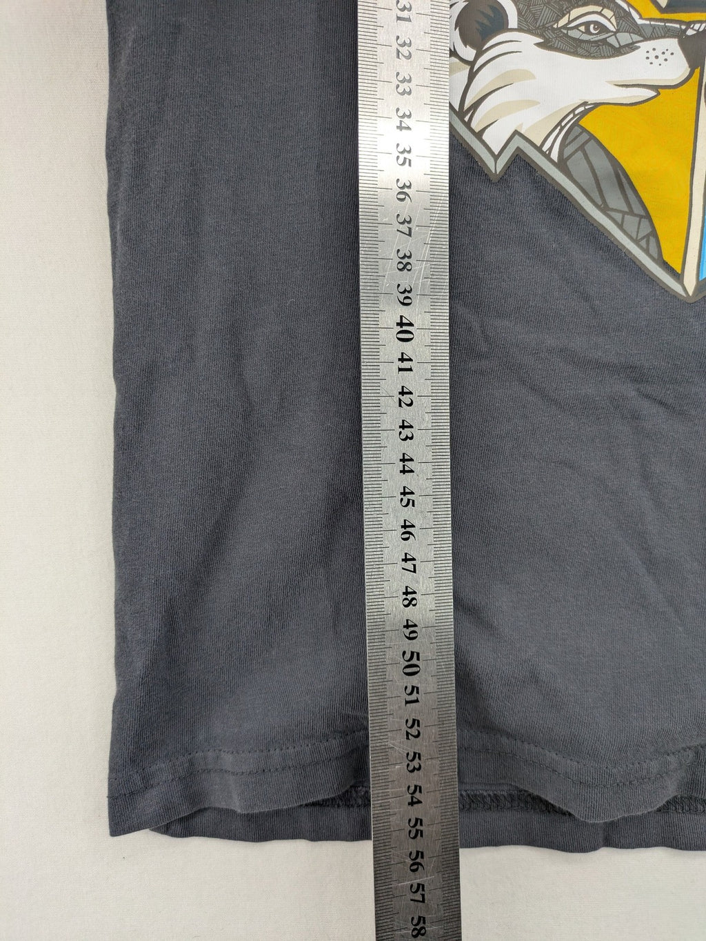 Harry Potter blue t-shirt featuring colorful Hogwarts crest and "I'd Rather Be At Hogwarts" slogan.