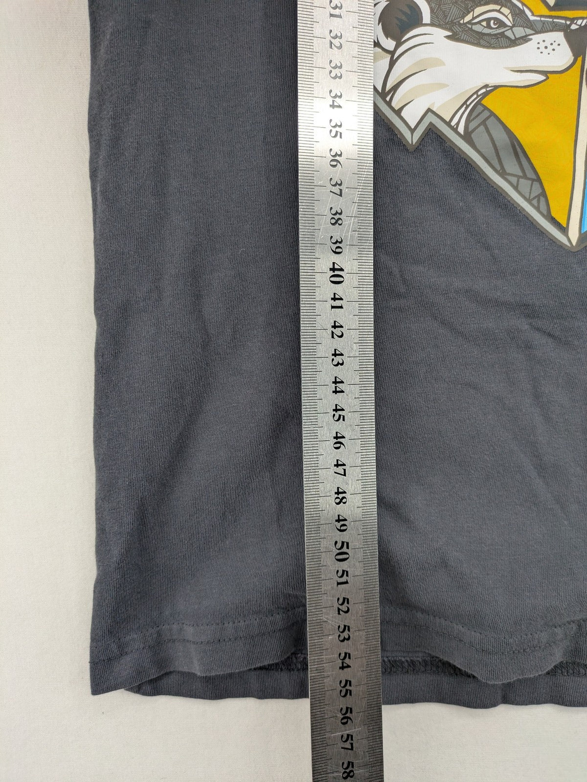 Harry Potter blue t-shirt featuring colorful Hogwarts crest and "I'd Rather Be At Hogwarts" slogan.