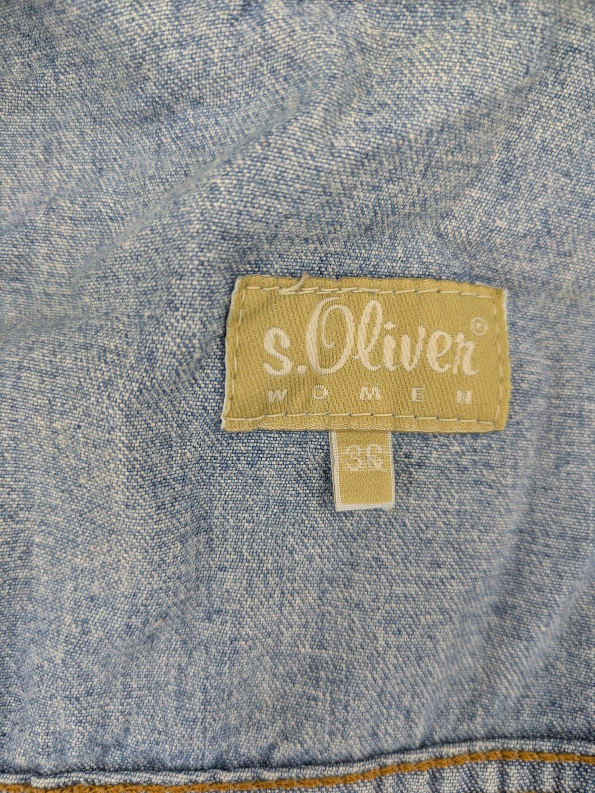 s.Oliver blue denim vest with button closure, pointed collar, and breast pockets.