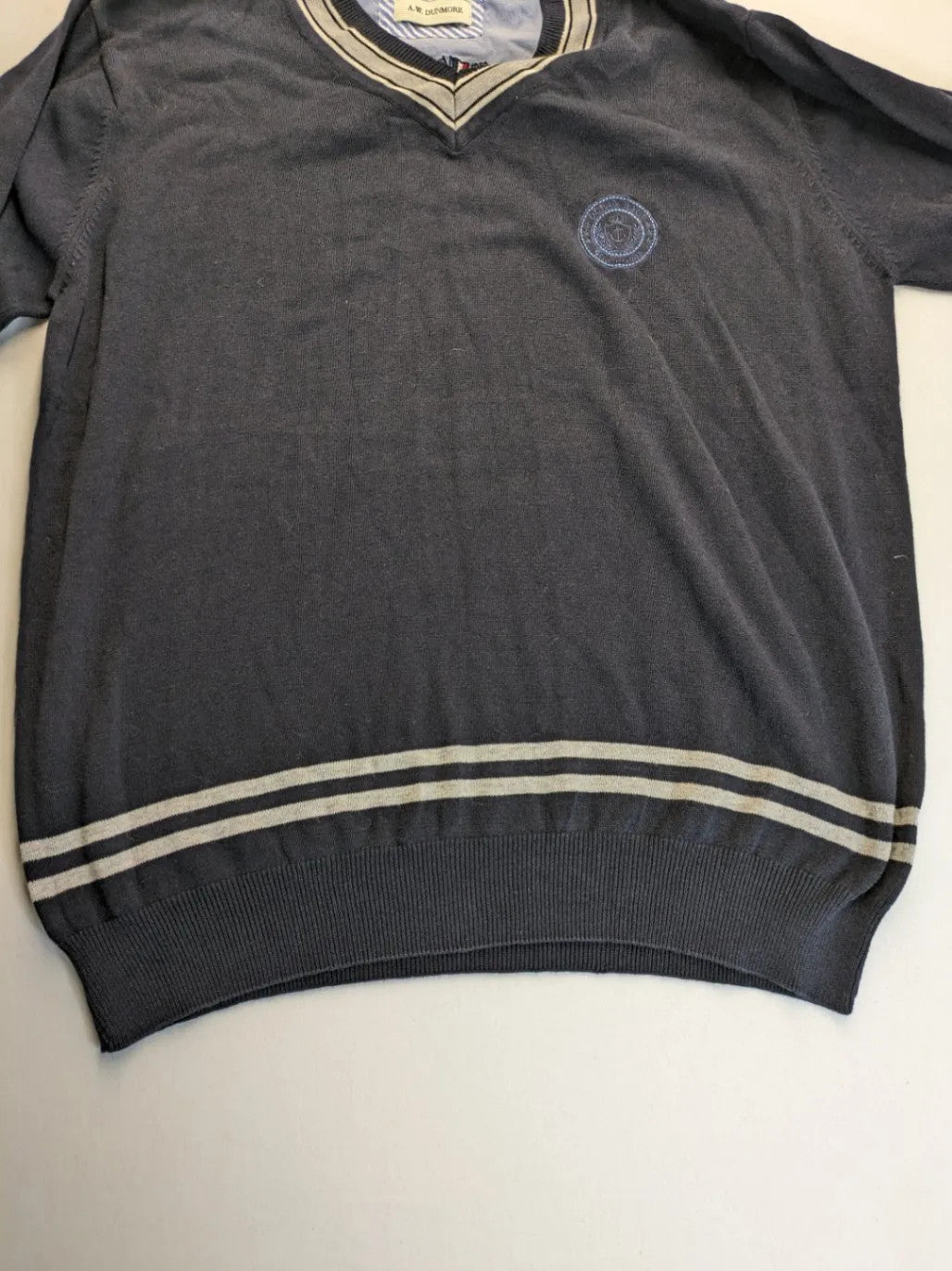 dunmore turtle neck jumper dark blue with striped trims and embroidered crest logo