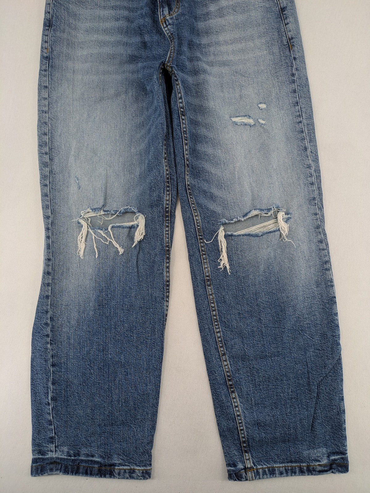 FSBN blue straight jeans with ripped distressed knees and classic button fly.
