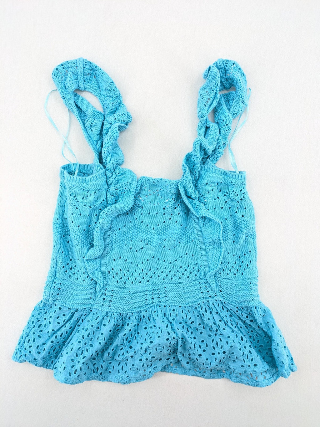 Springfield blue knit top with ruffled straps, peplum hem, and lace embroidery.