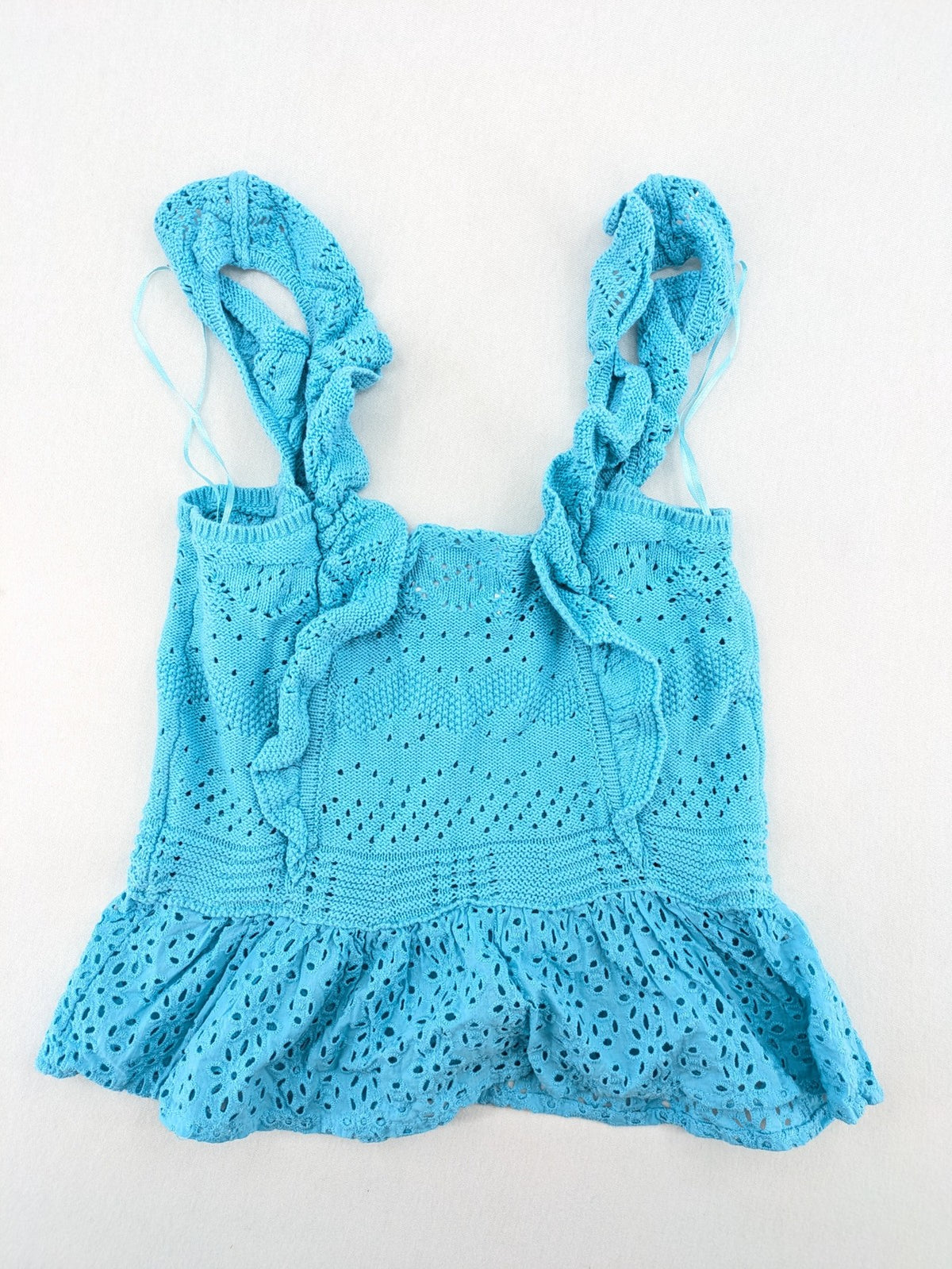 Springfield blue knit top with ruffled straps, peplum hem, and lace embroidery.