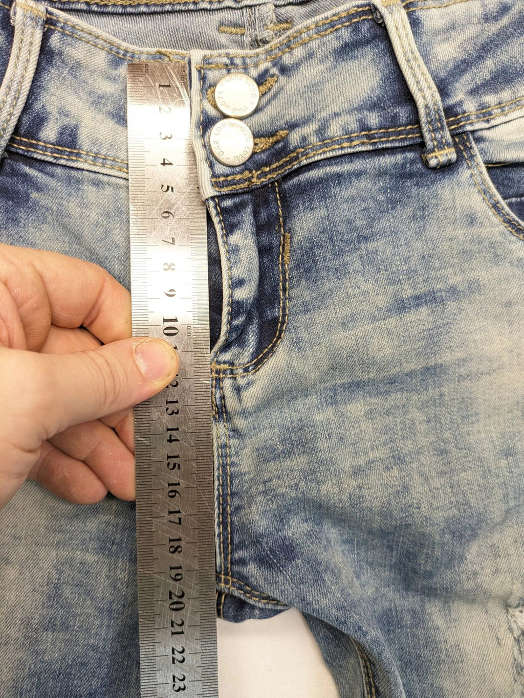 ONE LOVE DENIM blue straight jeans with distressed details and double button closure.