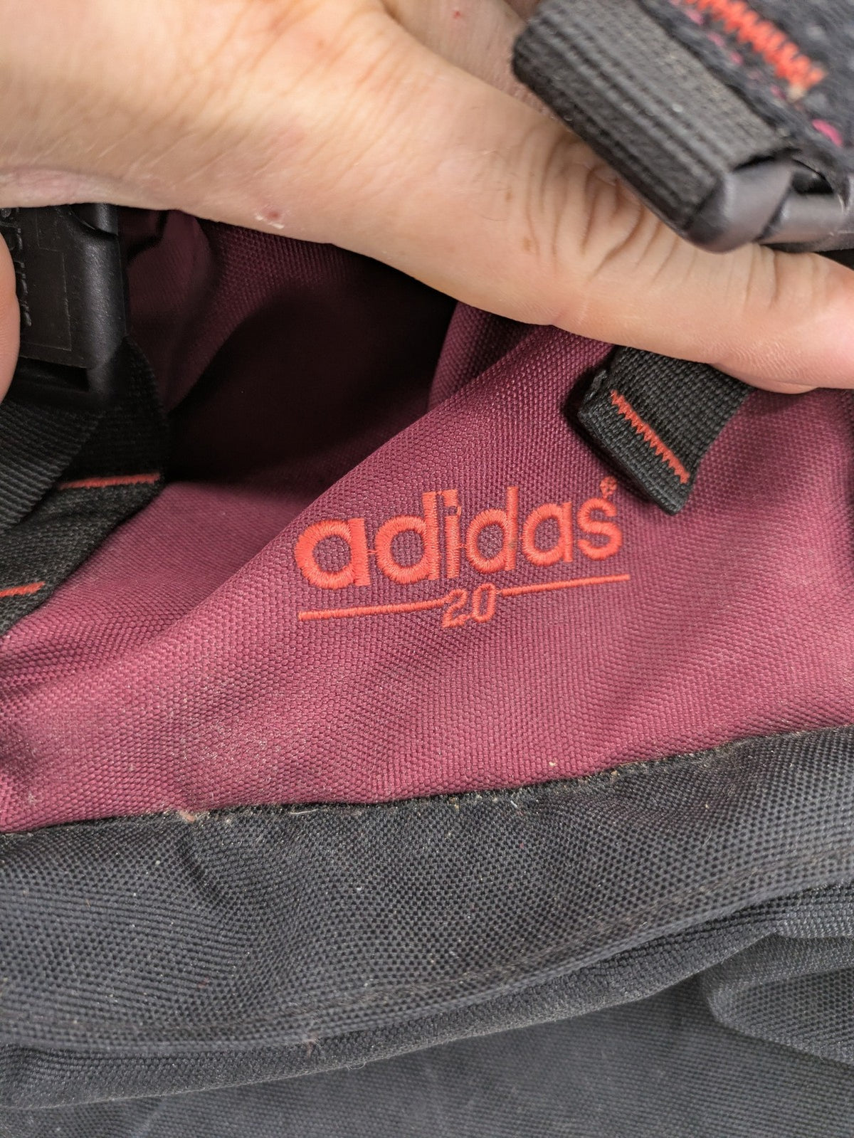 Adidas burgundy vintage rucksack with logo, Teflon fabric, and drawstring closure.