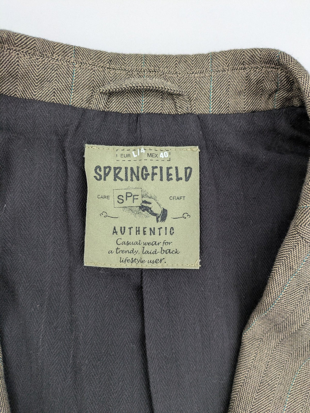 Springfield pink blazer with subtle pinstripe pattern and patch pockets.