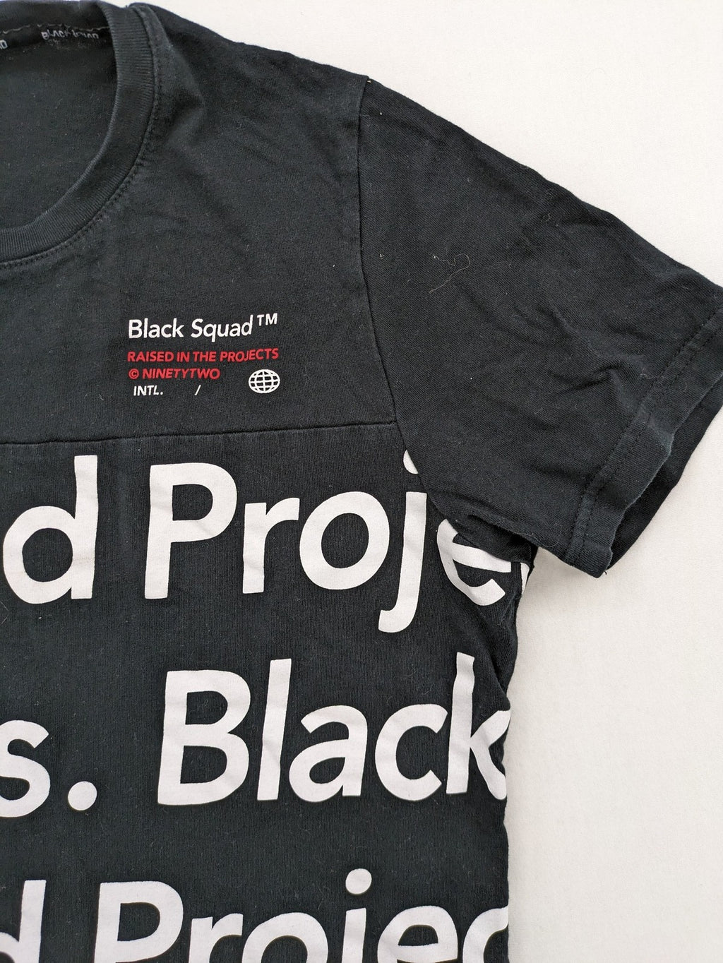 Black Squad black t-shirt all-over graphic print with logo patch on sleeve.