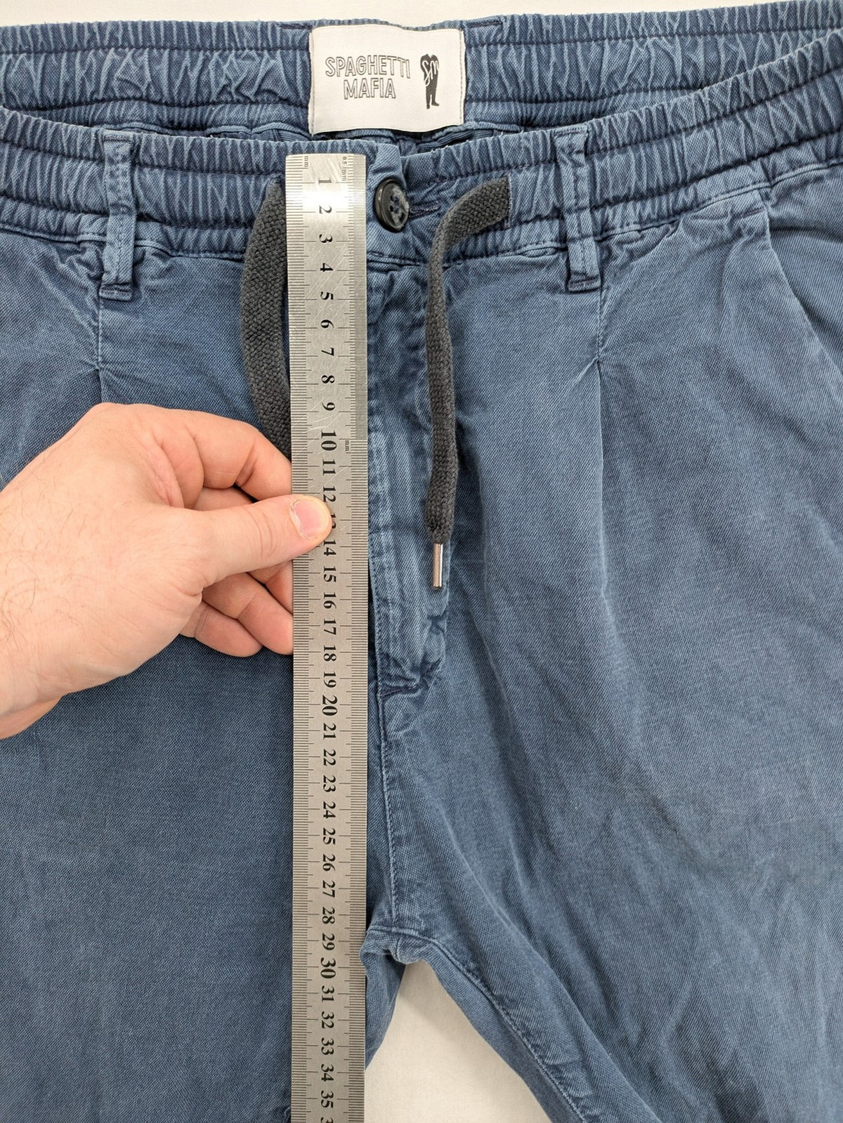 Spaghetti Mafia cream pants with elastic waistband, drawstring, and subtle front pleats.
