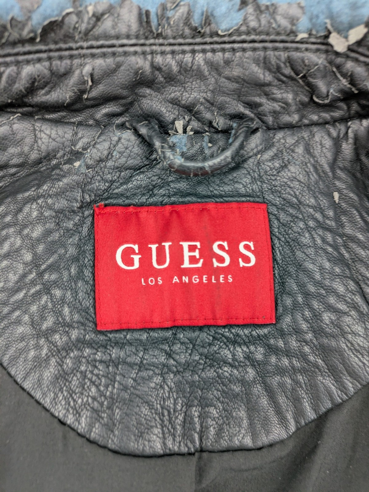 Guess black faux leather biker jacket with asymmetric zipper and multiple zip pockets.