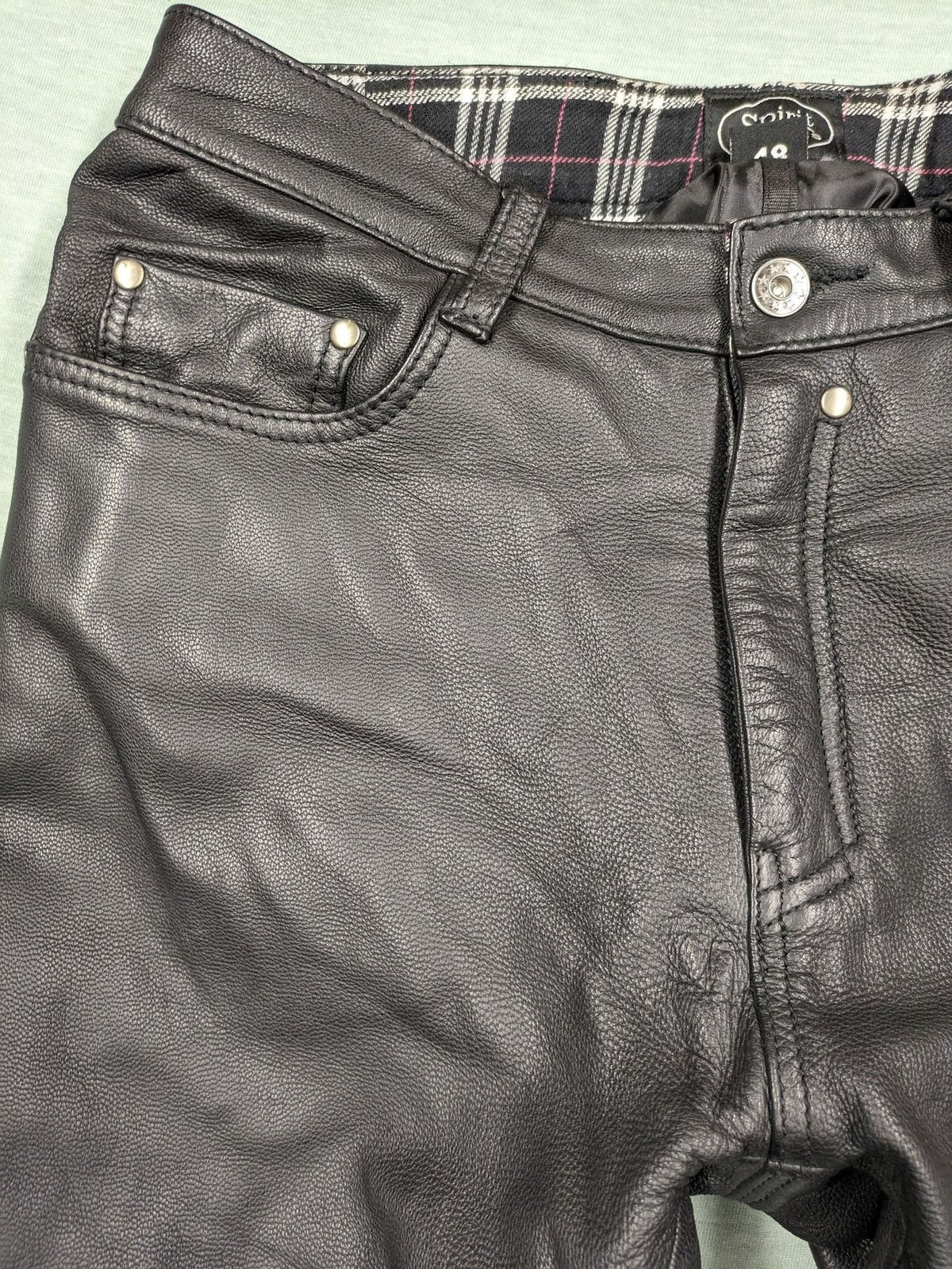 Spirit Motors black leather chaps with red and white accents, 5-pocket style, reinforced knees.