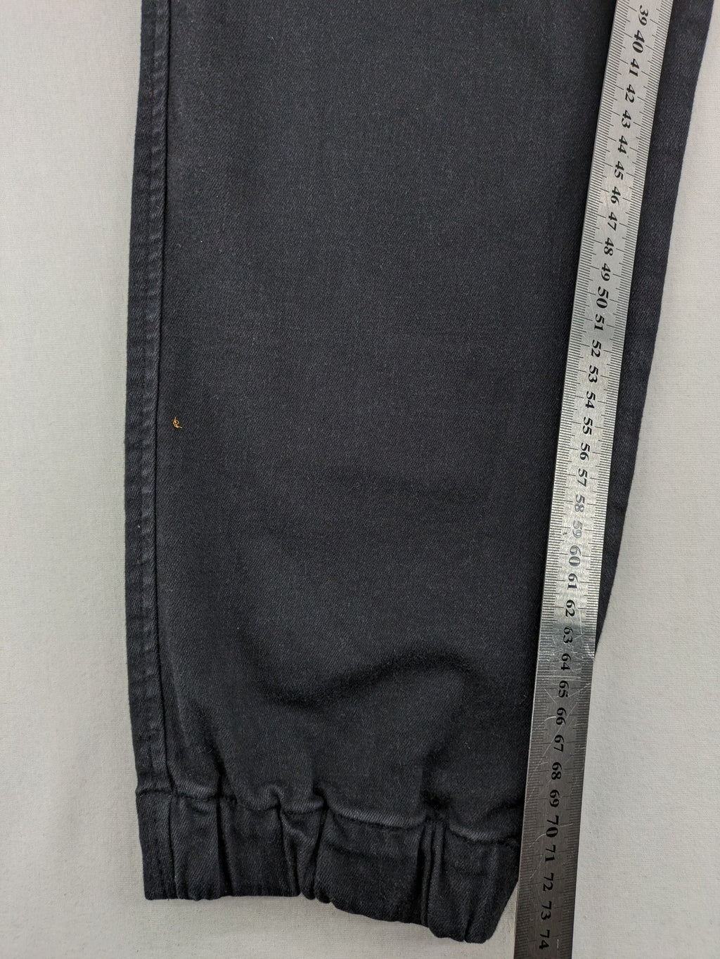 C&A grey jogger pants with elastic cuffs, drawstring waist, and multiple pockets.