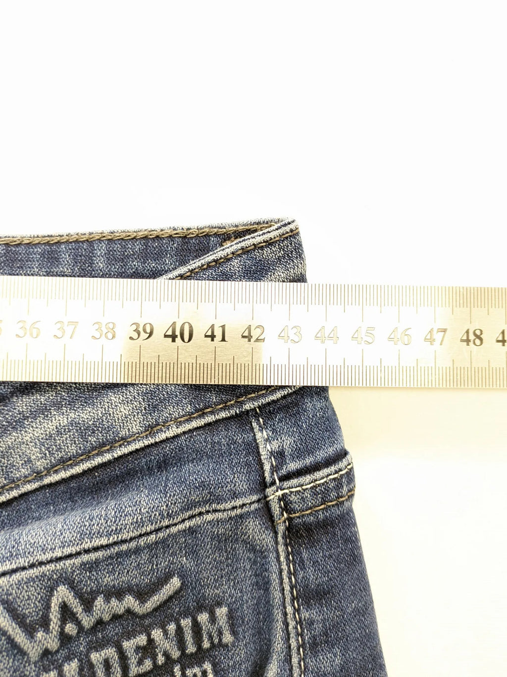 WAM Denim blue straight jeans with distressed details and button fly.
