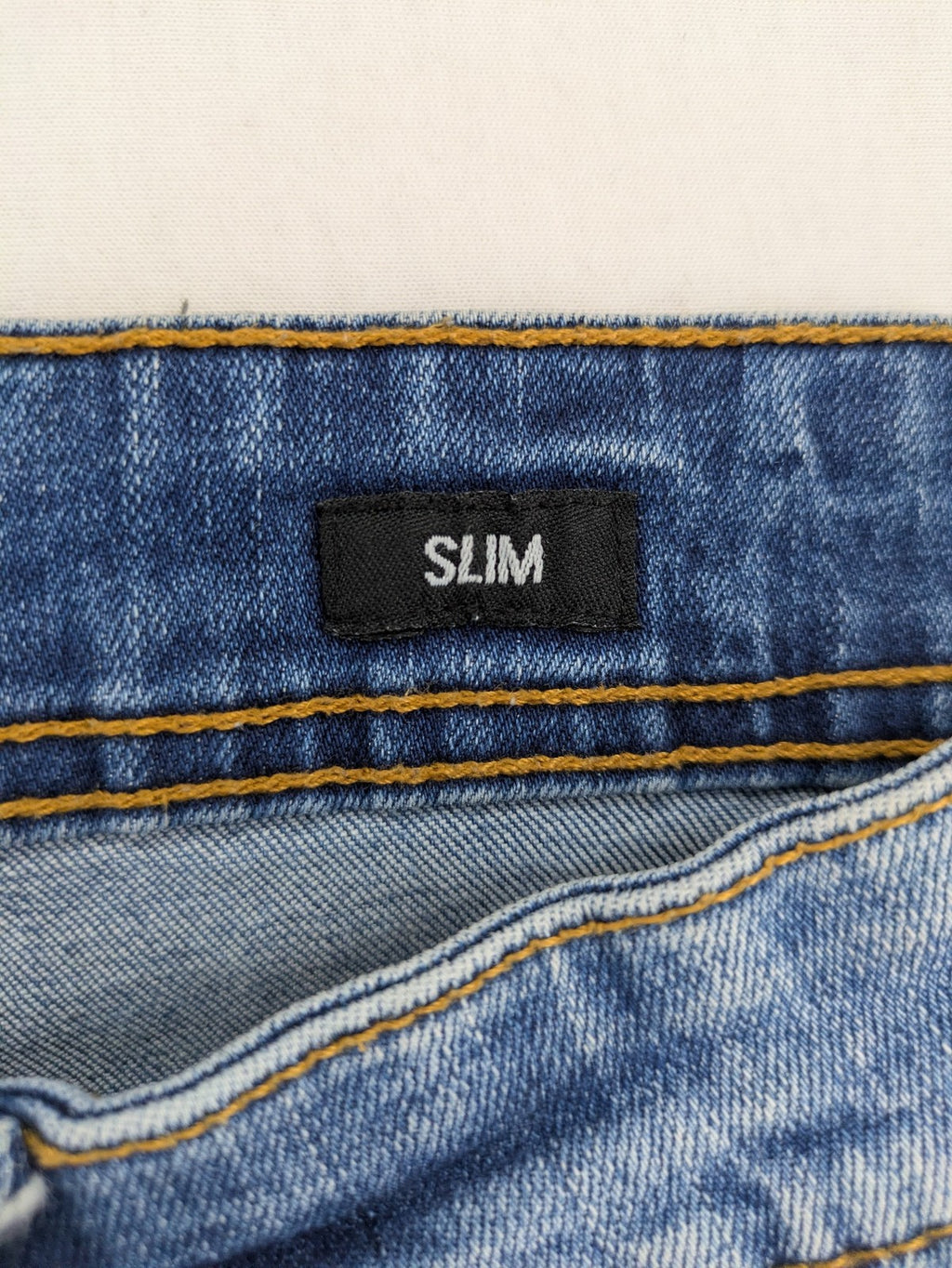 Smog blue denim shorts slim fit distressed details with rolled hem.