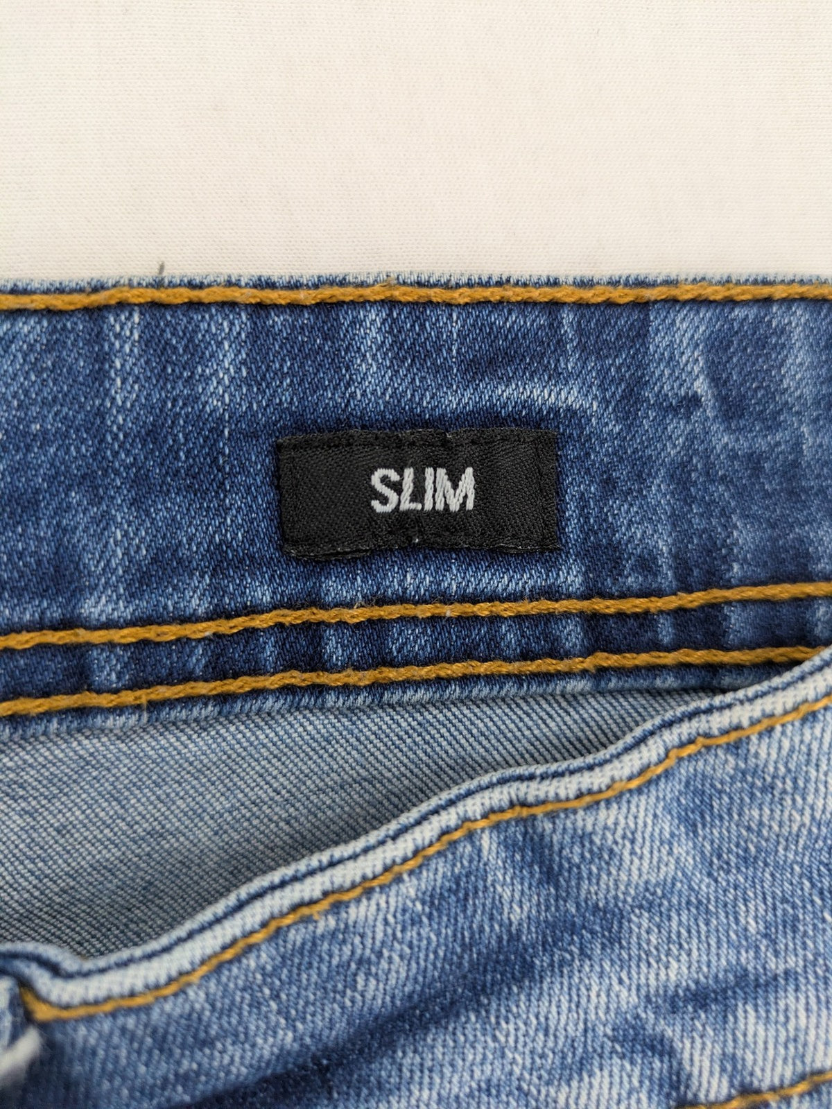 Smog blue denim shorts slim fit distressed details with rolled hem.