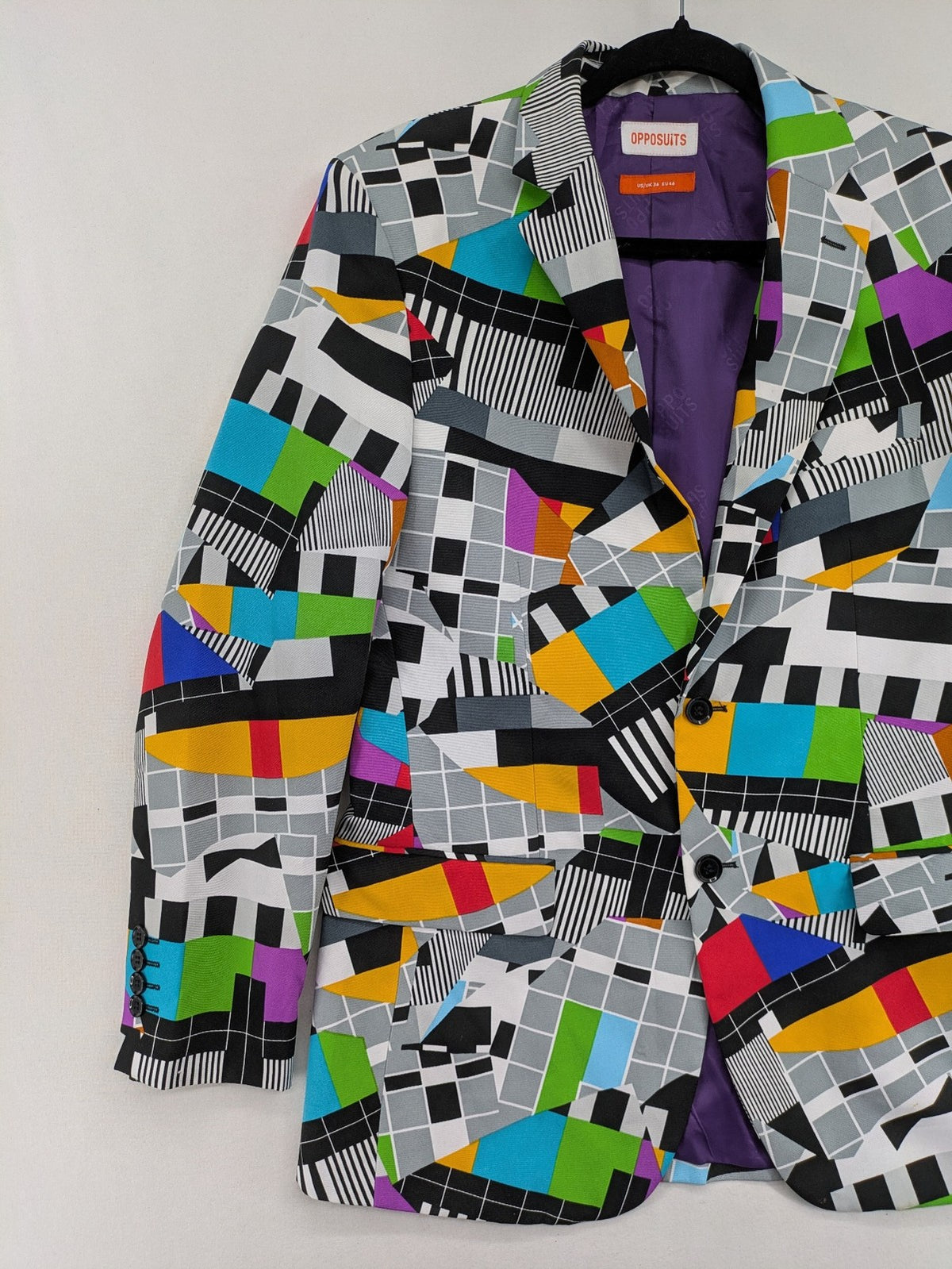 Opposuits blue and green blazer with vibrant geometric pattern and purple satin lining.