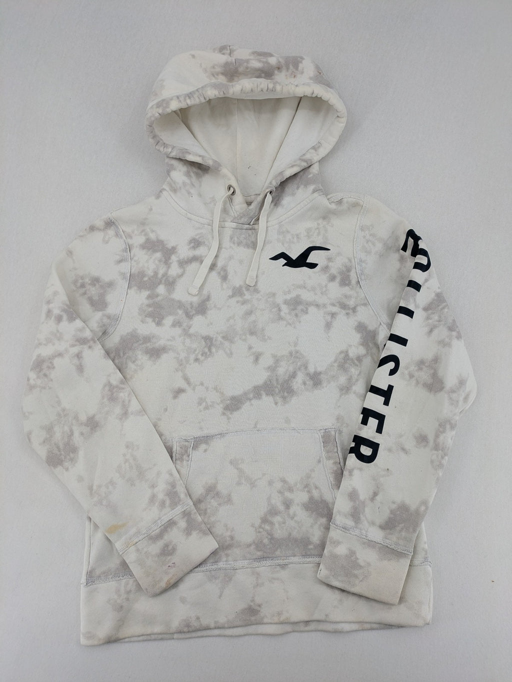 Hollister grey and white tie-dye hoodie with logo on chest, back, and sleeve.