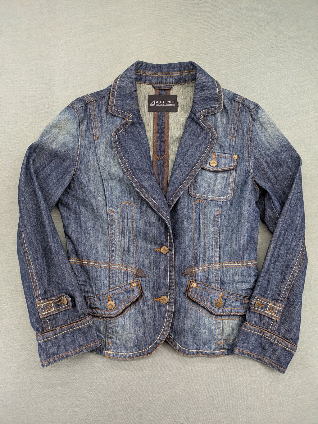 Authentic Clothing Company blue jeans blazer with contrast stitching and button closure.