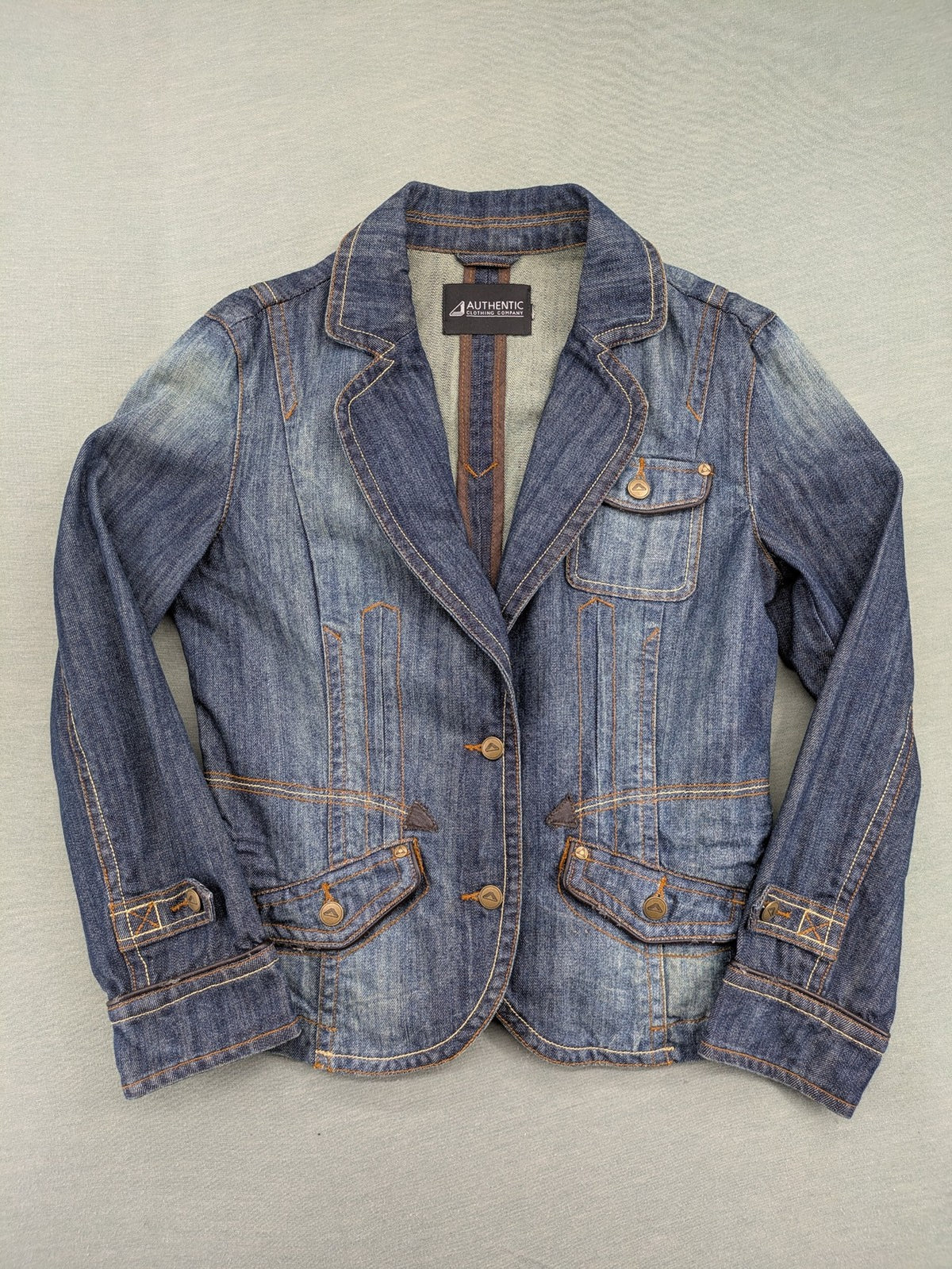 Authentic Clothing Company blue jeans blazer with contrast stitching and button closure.