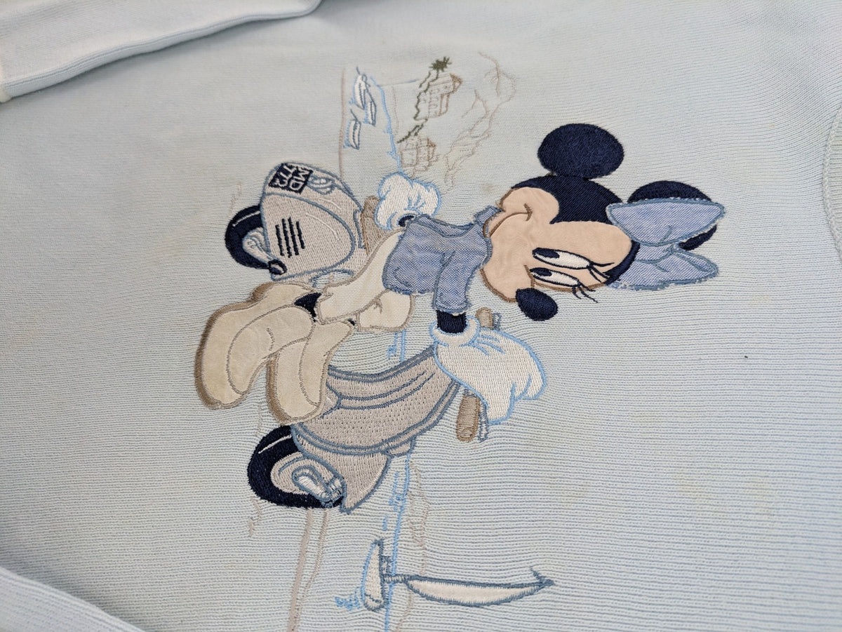 Donaldson multi turtle neck jumper light blue with embroidered Minnie Mouse graphic and ribbed texture.