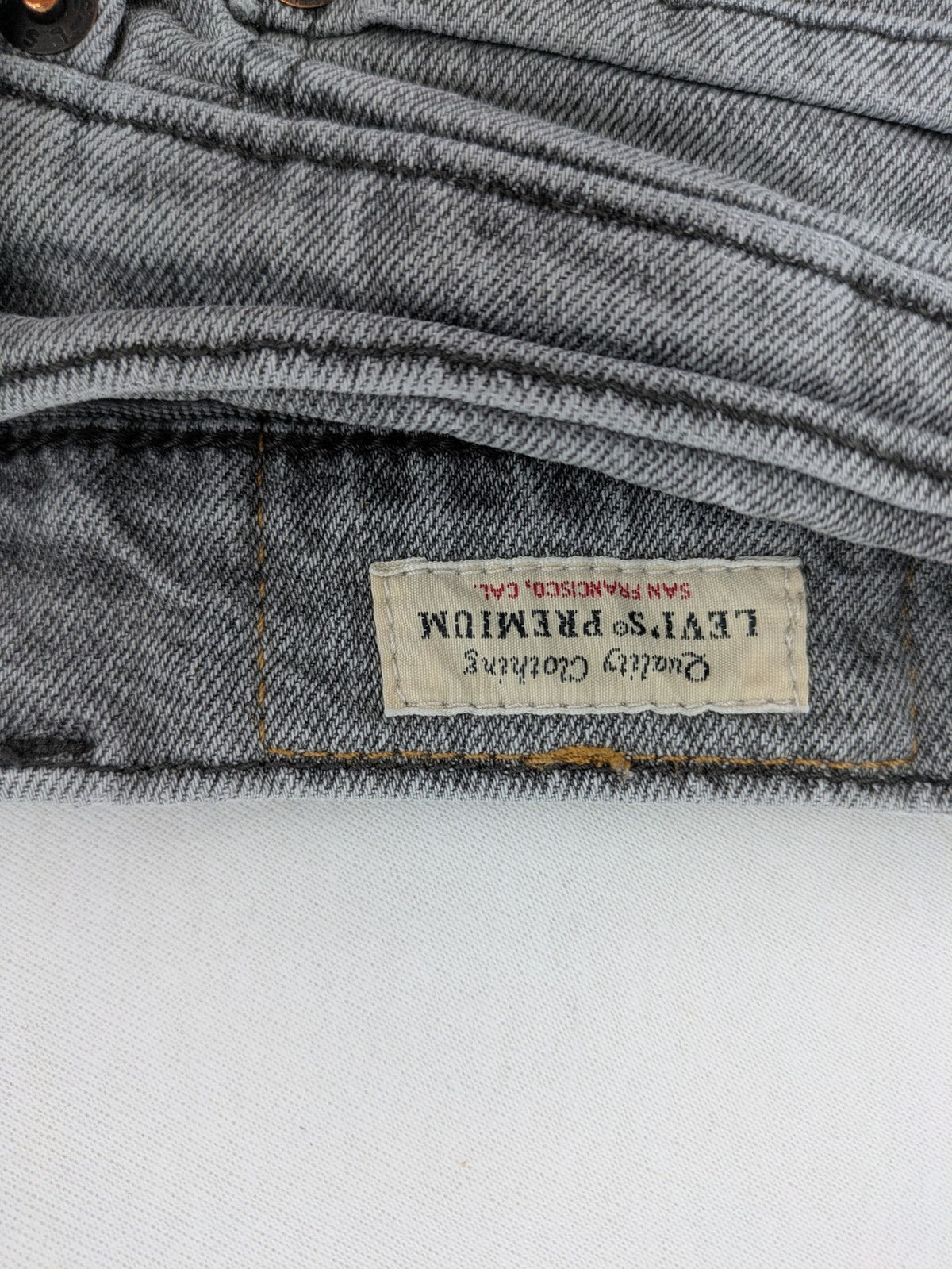 Levi's grey slim fit jeans with distressed knee details and classic logo patch.