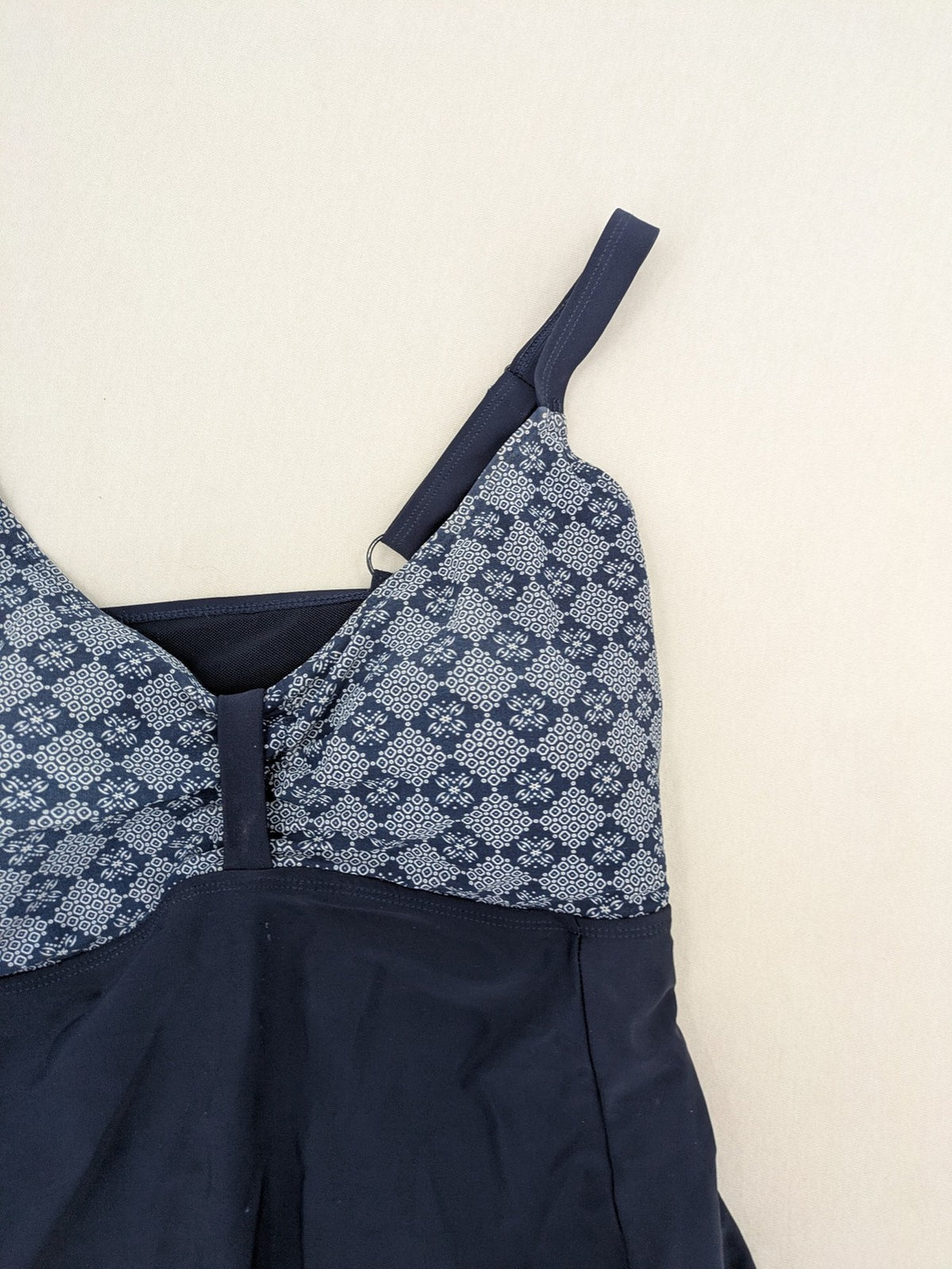 Muster blue one-piece swimsuit with geometric pattern and adjustable straps.