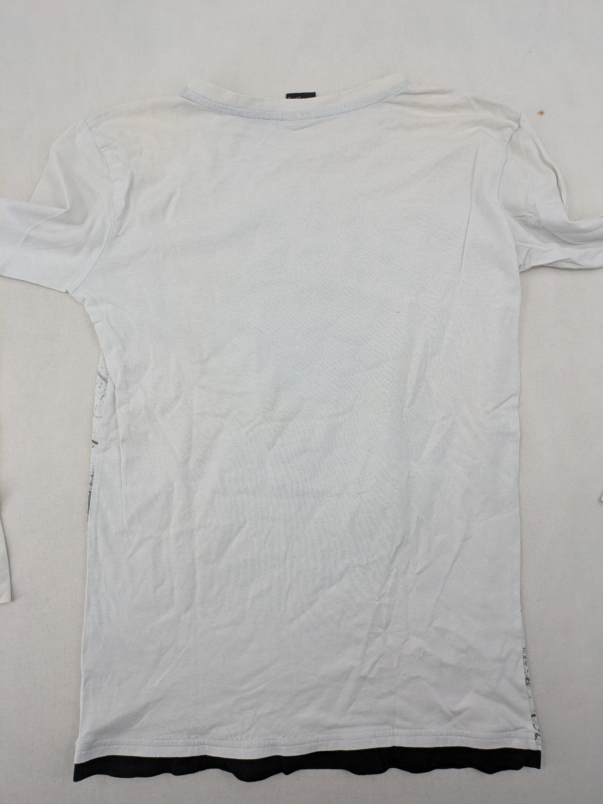 Chapter Young long sleeve shirt white with black skateboarder graphic and motivational text.