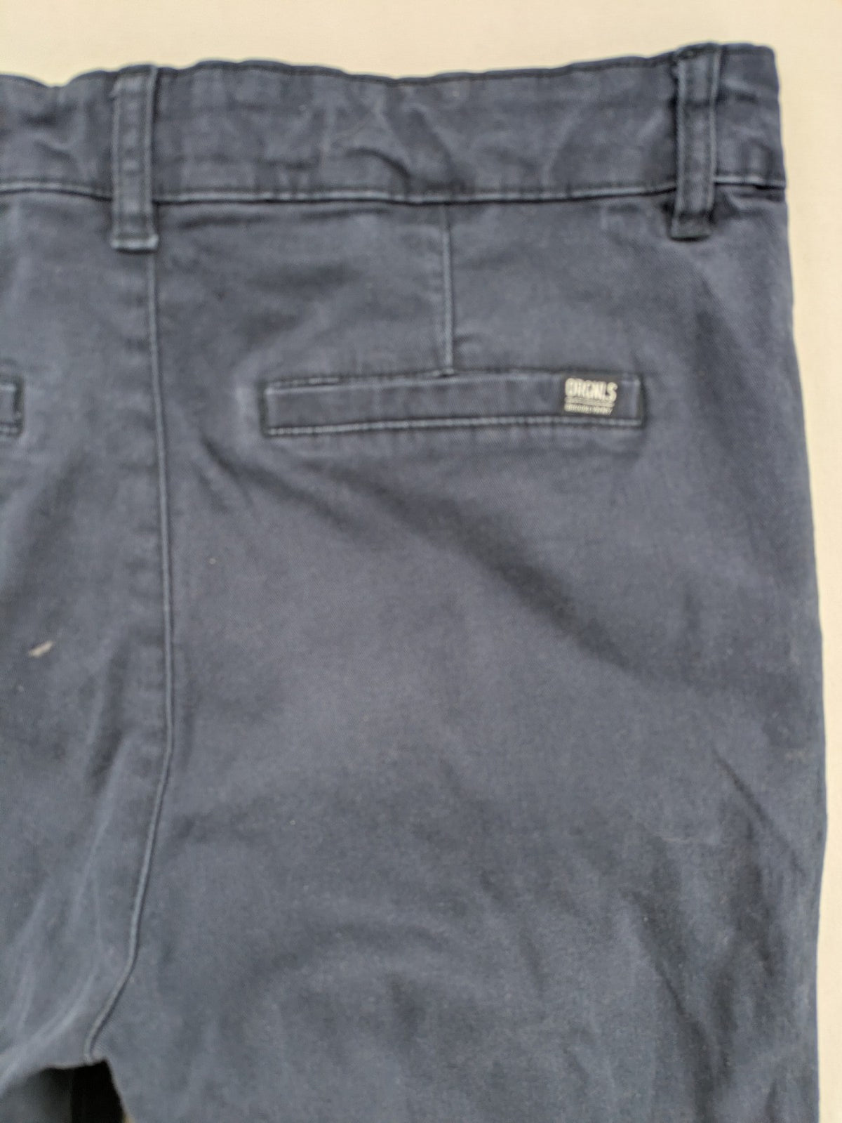 H&M navy chino pants with stretch, classic design, soft cotton blend material.