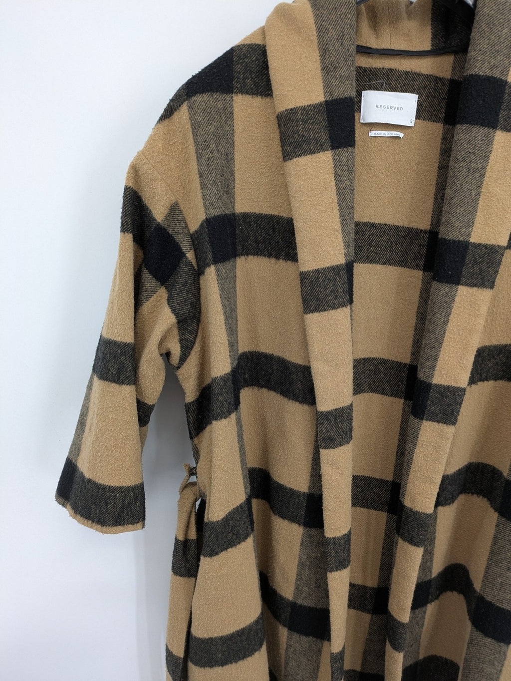 Reserved cream coat with brown and black check pattern, fringe hem, wool blend material.