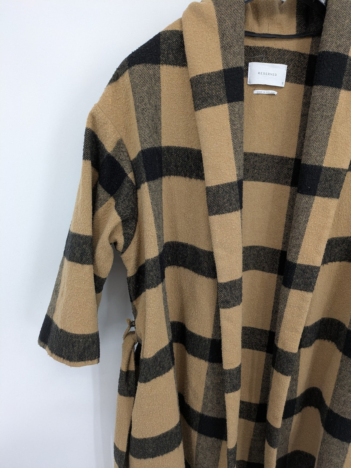 Reserved cream coat with brown and black check pattern, fringe hem, wool blend material.