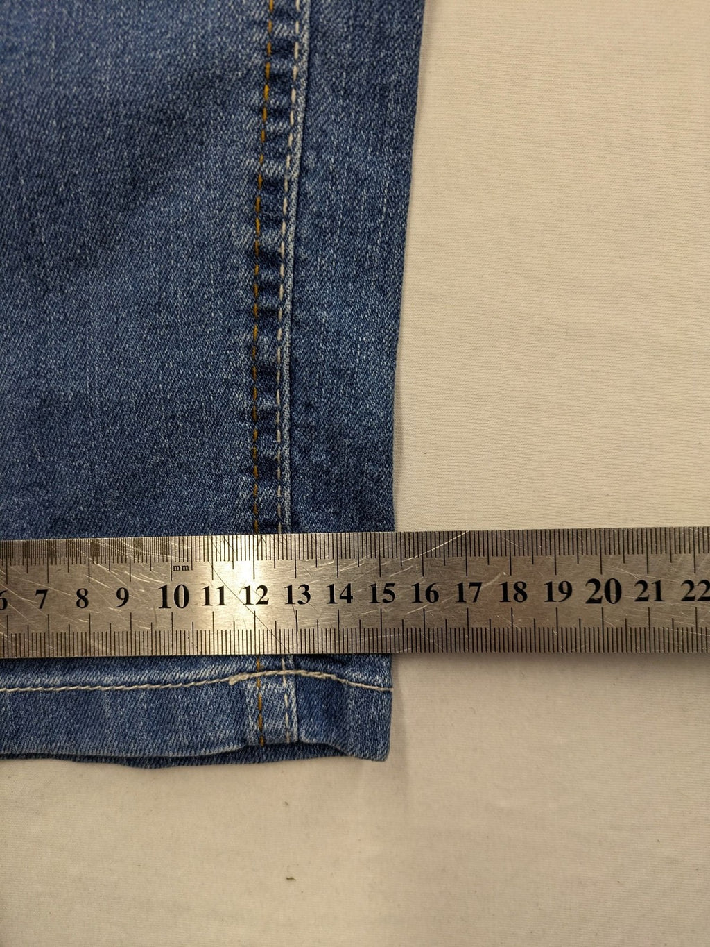Rainbow blue straight jeans with elastic waistband and decorative knee stitching.