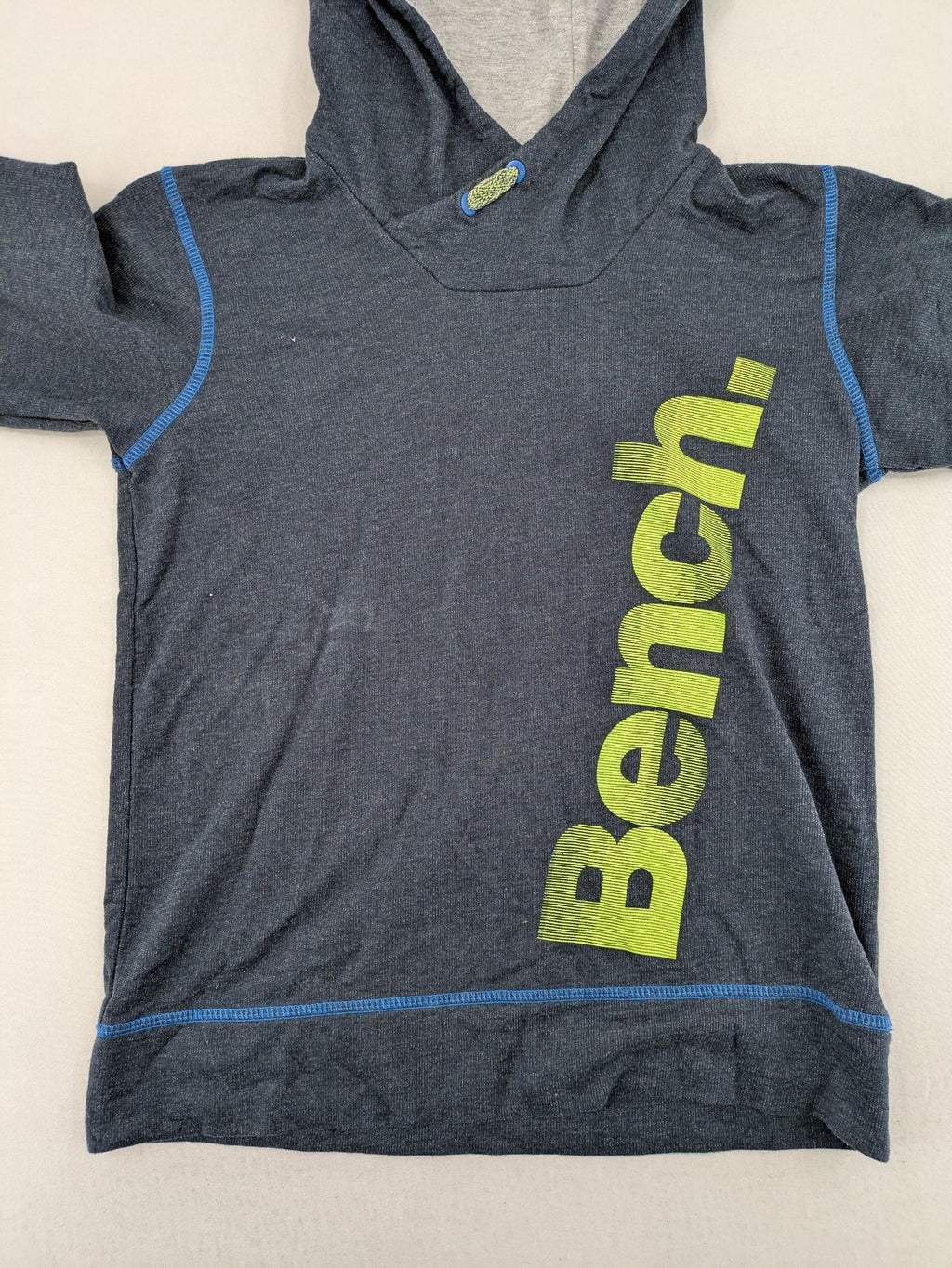 Bench hoodie dark grey with neon green logo and blue contrast stitching.