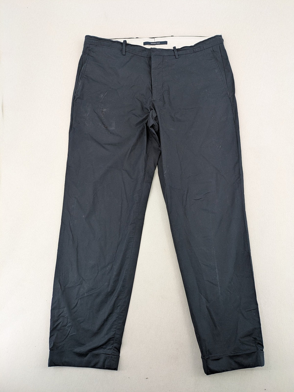 Mango Man black chinos flat front design with zipper and button closure.