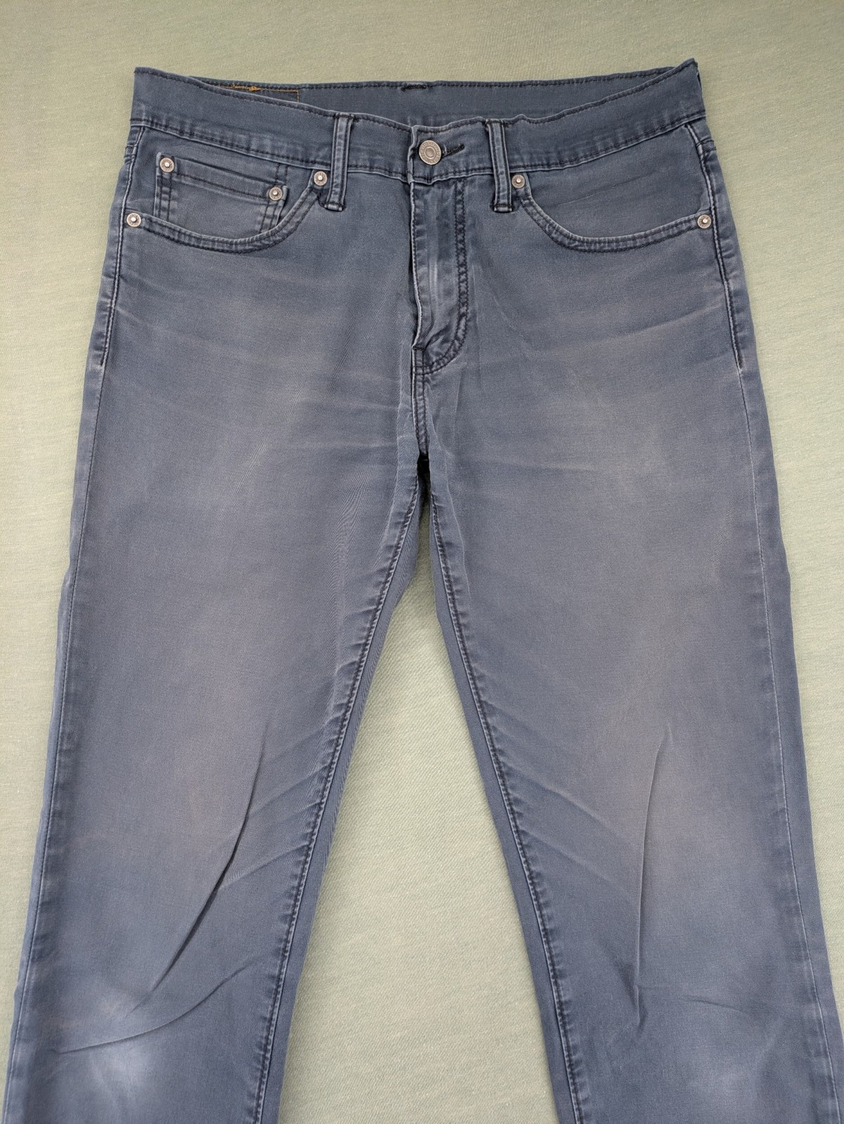 Levi's blue slim fit jeans with faded wash and classic 5-pocket design.