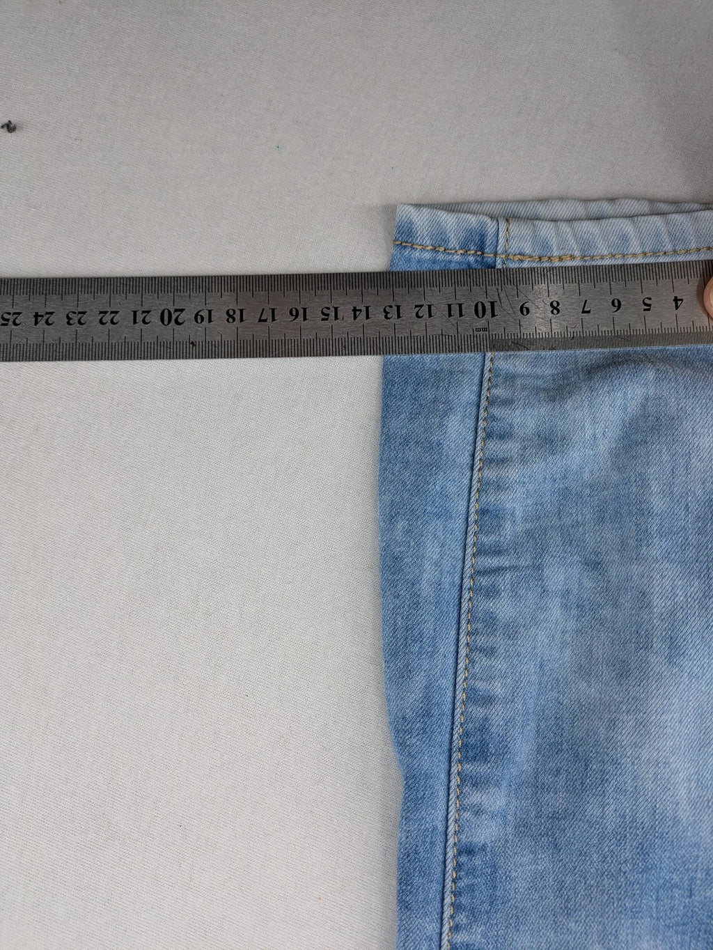 Lexxury blue skinny jeans distressed with knee rips and light wash finish.