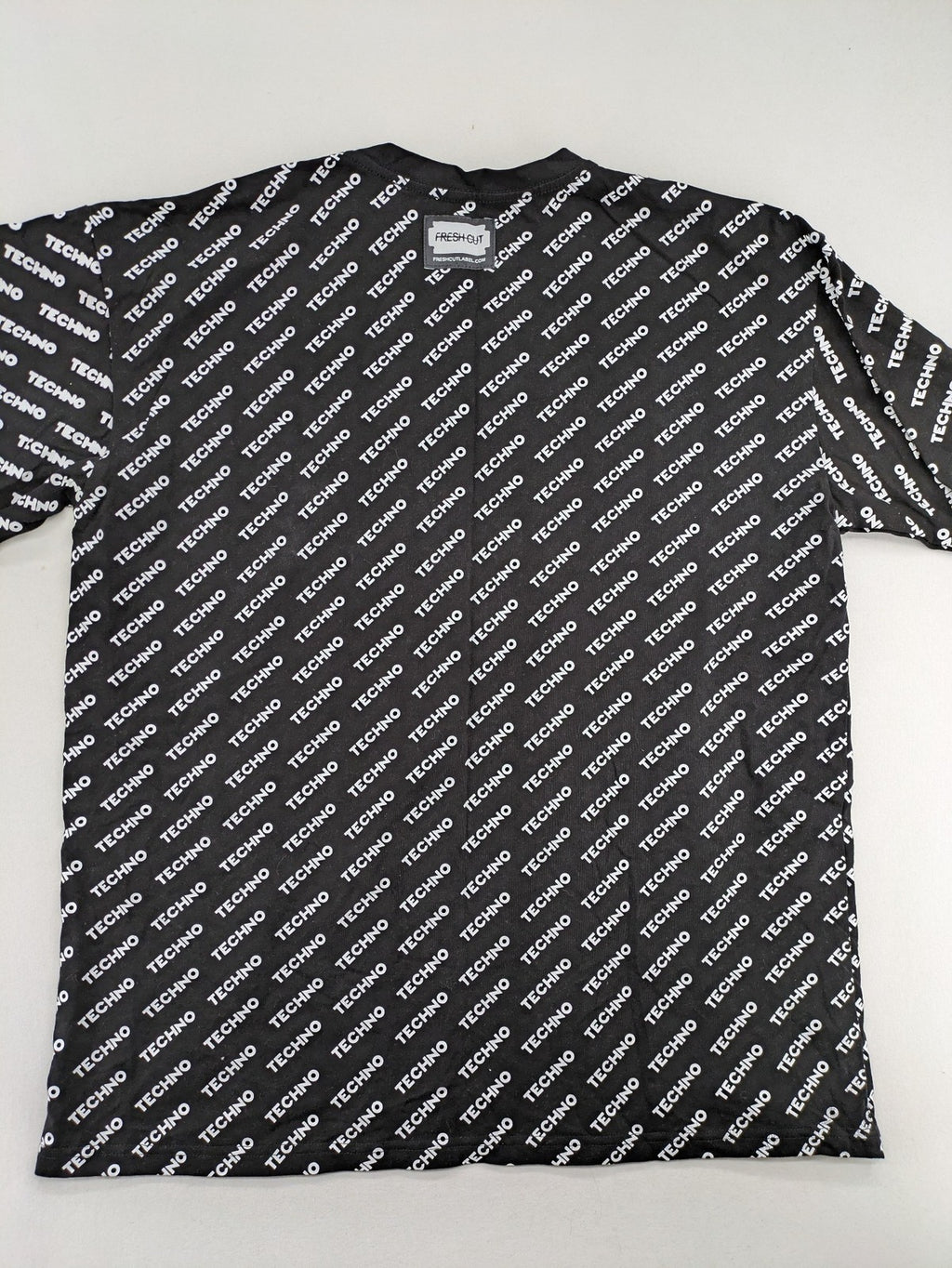 Fresh Cut black techno t-shirt all-over print with bold "TECHNO" graphic design.