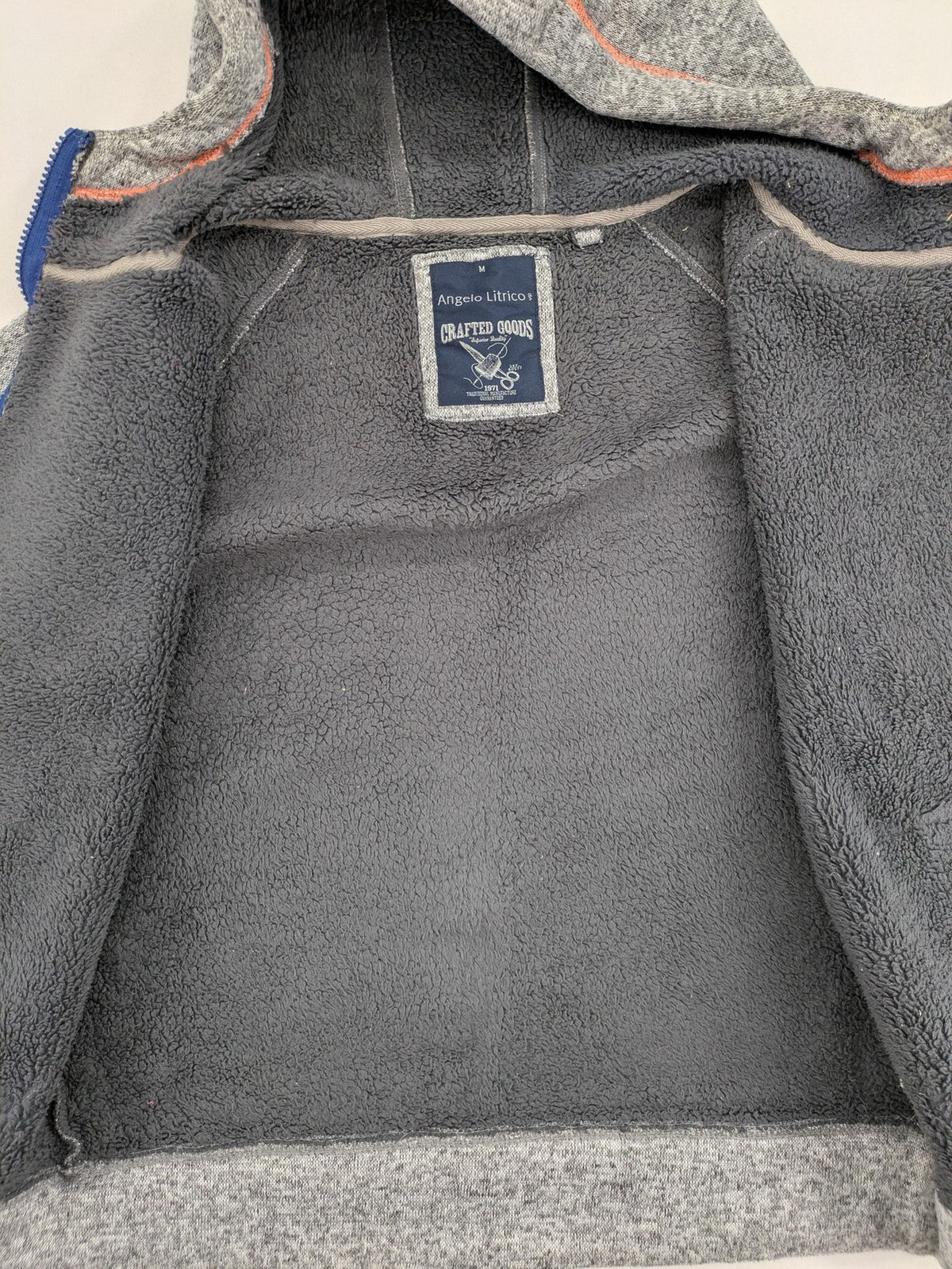 Angelo Litrico grey hoodie with teddy fleece lining, adjustable hood, and retro ski patch.