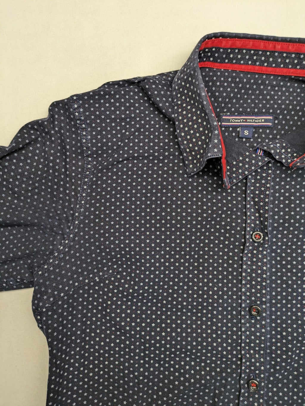 Tommy Hilfiger navy button-down shirt with white star pattern and embroidered flag logo.