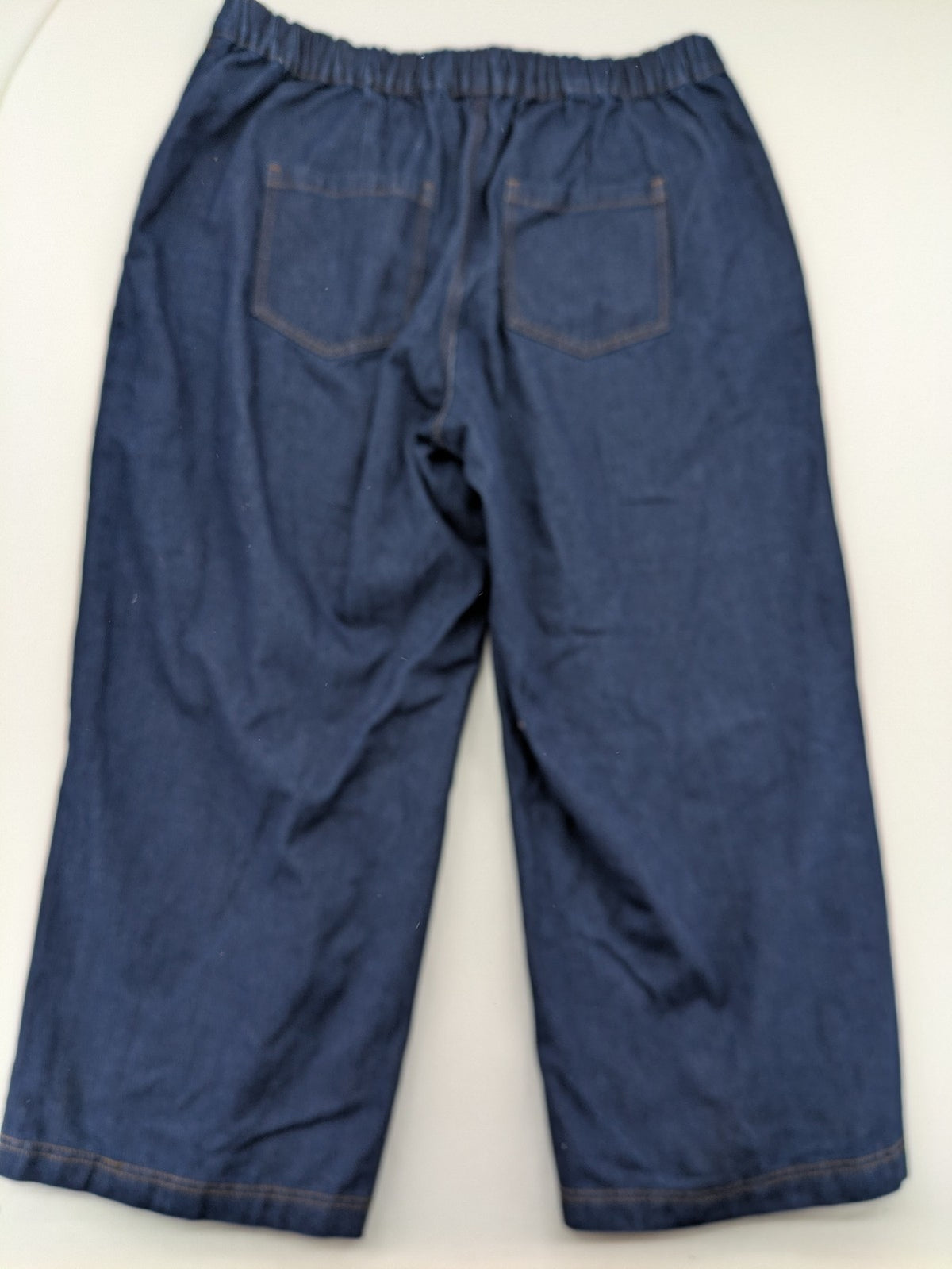 Emery Rose pink culotte pants with wide legs, double button closure, and soft denim blend.
